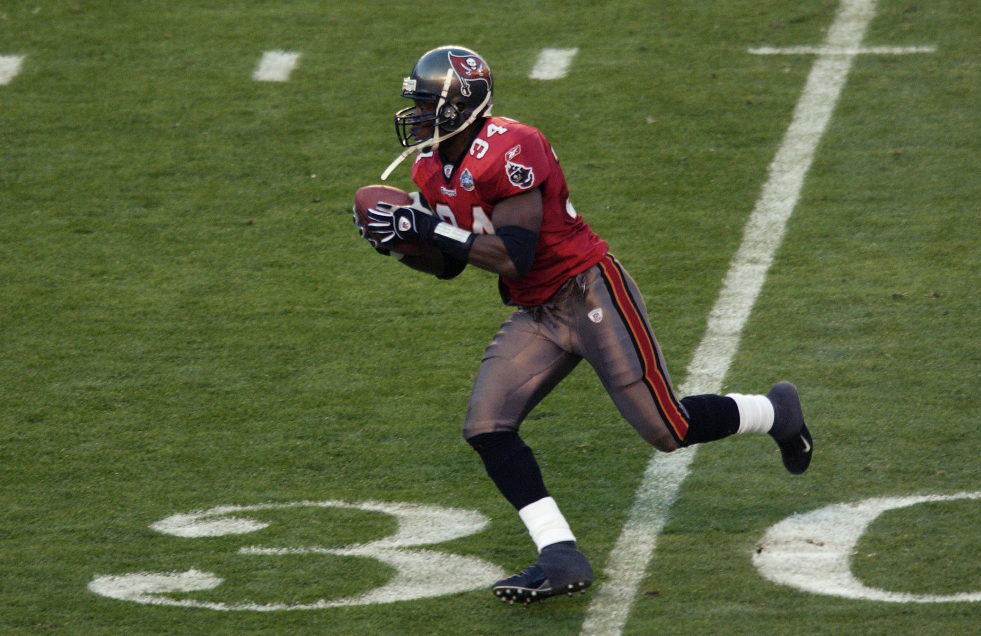 SAN DIEGO - JANUARY 26:  Safety Dexter Jackson #34 of the Tampa Bay Buccaneers returns the interception against the Oakland Raiders during the second quarter of Super Bowl XXXVII on January 26, 2003 at Qualcomm Stadium in San Diego, California.  Jackson h