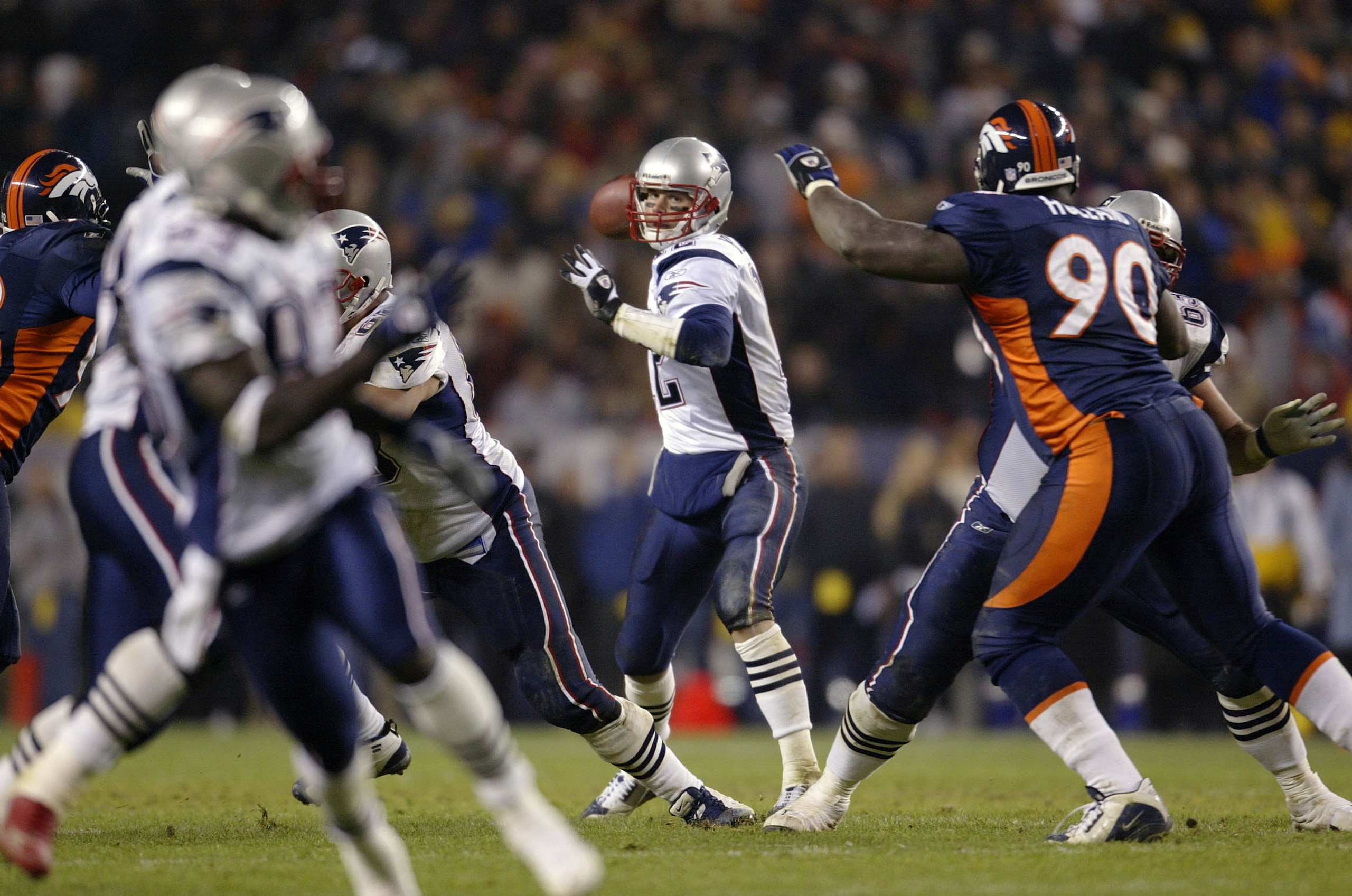 DENVER - NOVEMBER 3:  Quarterback Tom Brady #12 of the New England Patriots throws against the Denver Broncos late in the fourth quarter during Monday Night Football November 3, 2003 at Invesco Field at Mile High in Denver, Colorado  The Patriots won 30-2