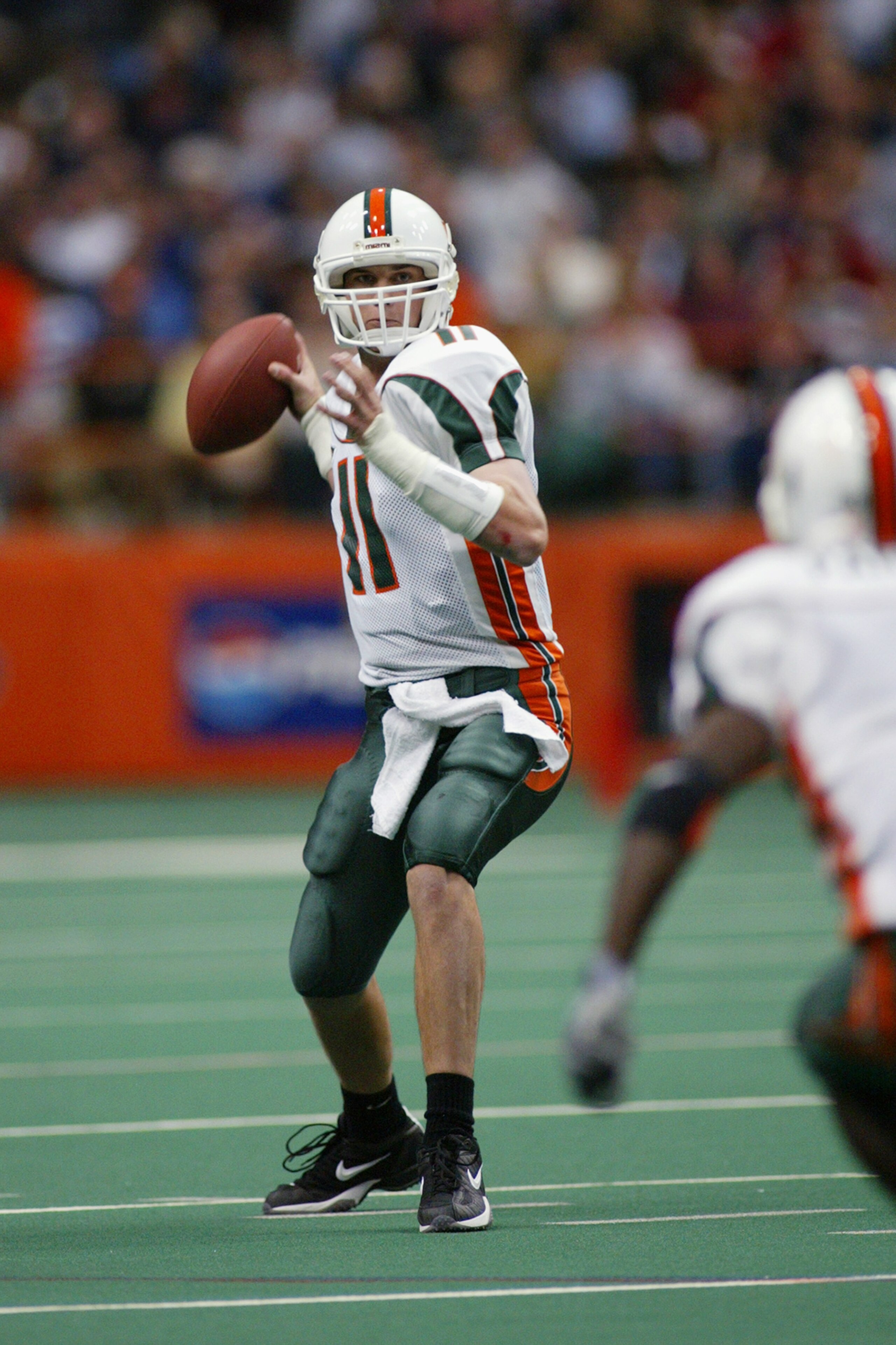 SYRACUSE, NY - NOVEMBER 30:  Ken Dorsey #11 of the University of Miami prepares to throw to Roscoe Parrish #1 during the game against Syracuse University at the Carrier Dome on November 30, 2002 in Syracuse, New York.  Miami won 49-7.  (Photo by Rick Stew
