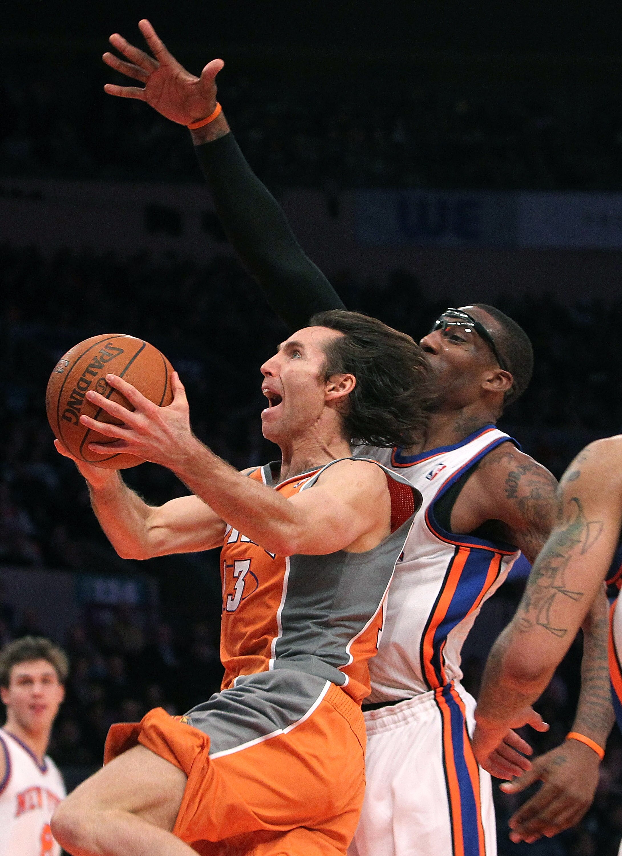NEW YORK, NY - JANUARY 17:  Steve Nash #13 of the Phoenix Suns drives to the basket against Amar'e Stoudemire #1 of the New York Knicks at Madison Square Garden on January 17, 2011 in New York City. NOTE TO USER: User expressly acknowledges and agrees tha