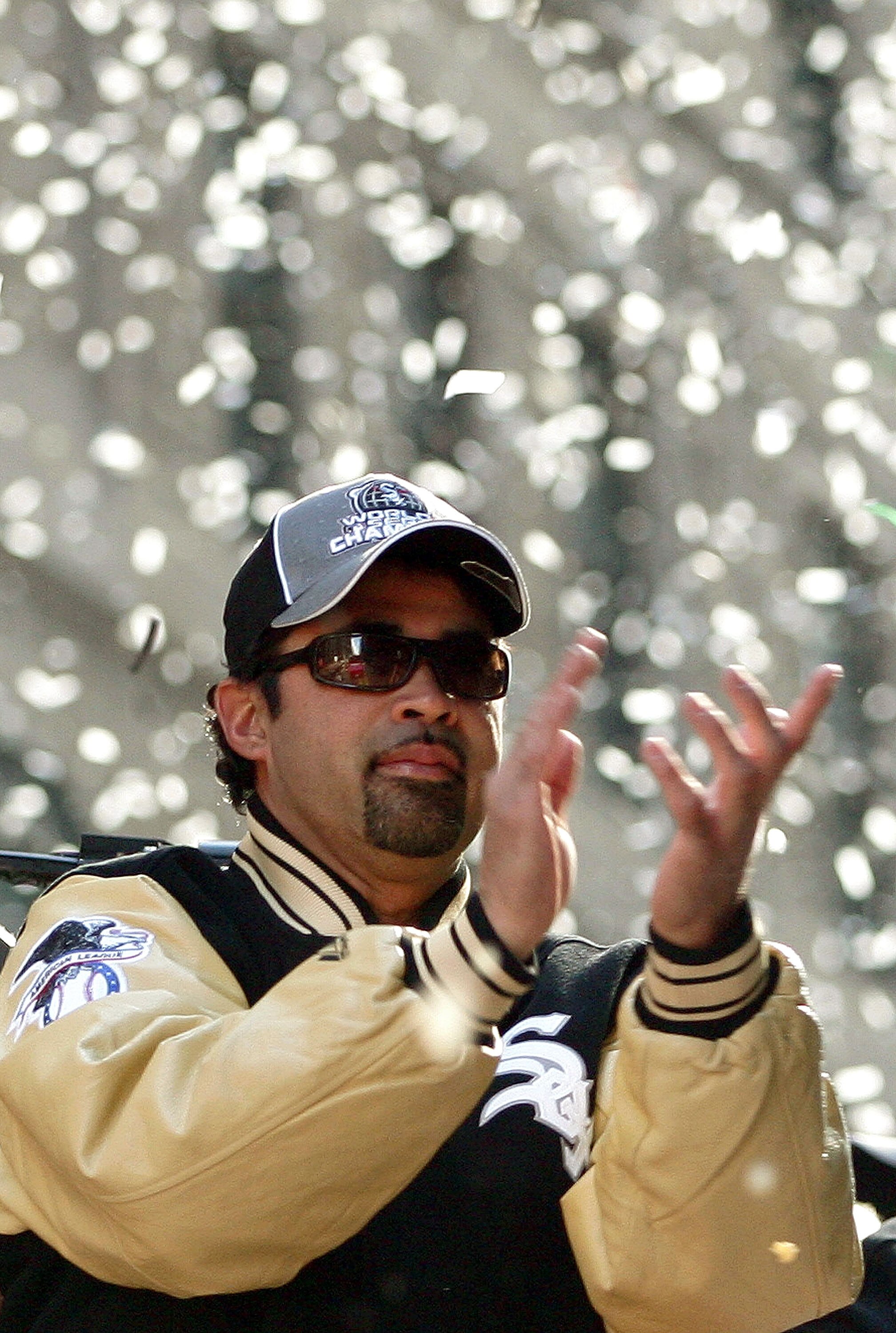 CHICAGO - OCTOBER 28:  Chicago White Sox manager Ozzie Guillen claps with fans as he rides atop a double-decker bus during a ticker-tape parade for the White Sox baseball team October 28, 2005 in downtown Chicago, Illinois. The Chicago White Sox won their