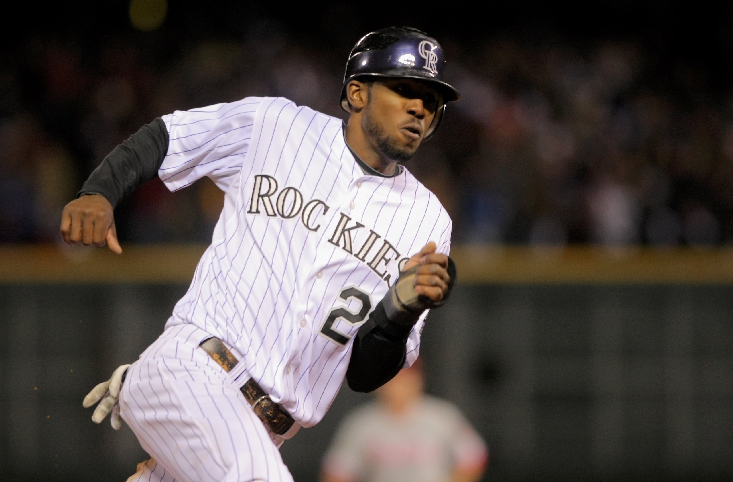 DENVER - OCTOBER 12:  Dexter Fowler #24 of the Colorado Rockies rounds third to score the game tying run against the Philadelphia Phillies in the bottom of the eighth inning in Game Four of the NLDS during the 2009 MLB Playoffs at Coors Field on October 1