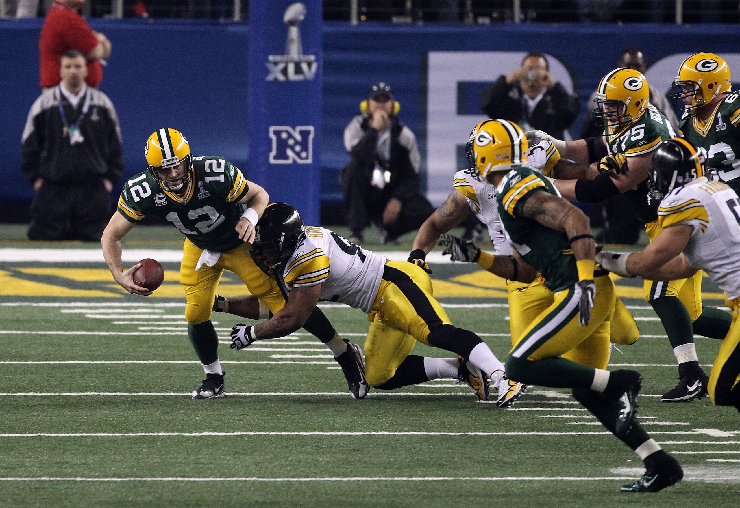 ARLINGTON, TX - FEBRUARY 06: Aaron Rodgers #12 of the Green Bay Packers is sacked by James Harrison #92 of the Pittsburgh Steelers during the second half of Super Bowl XLV at Cowboys Stadium on February 6, 2011 in Arlington, Texas.  (Photo by Streeter Lec