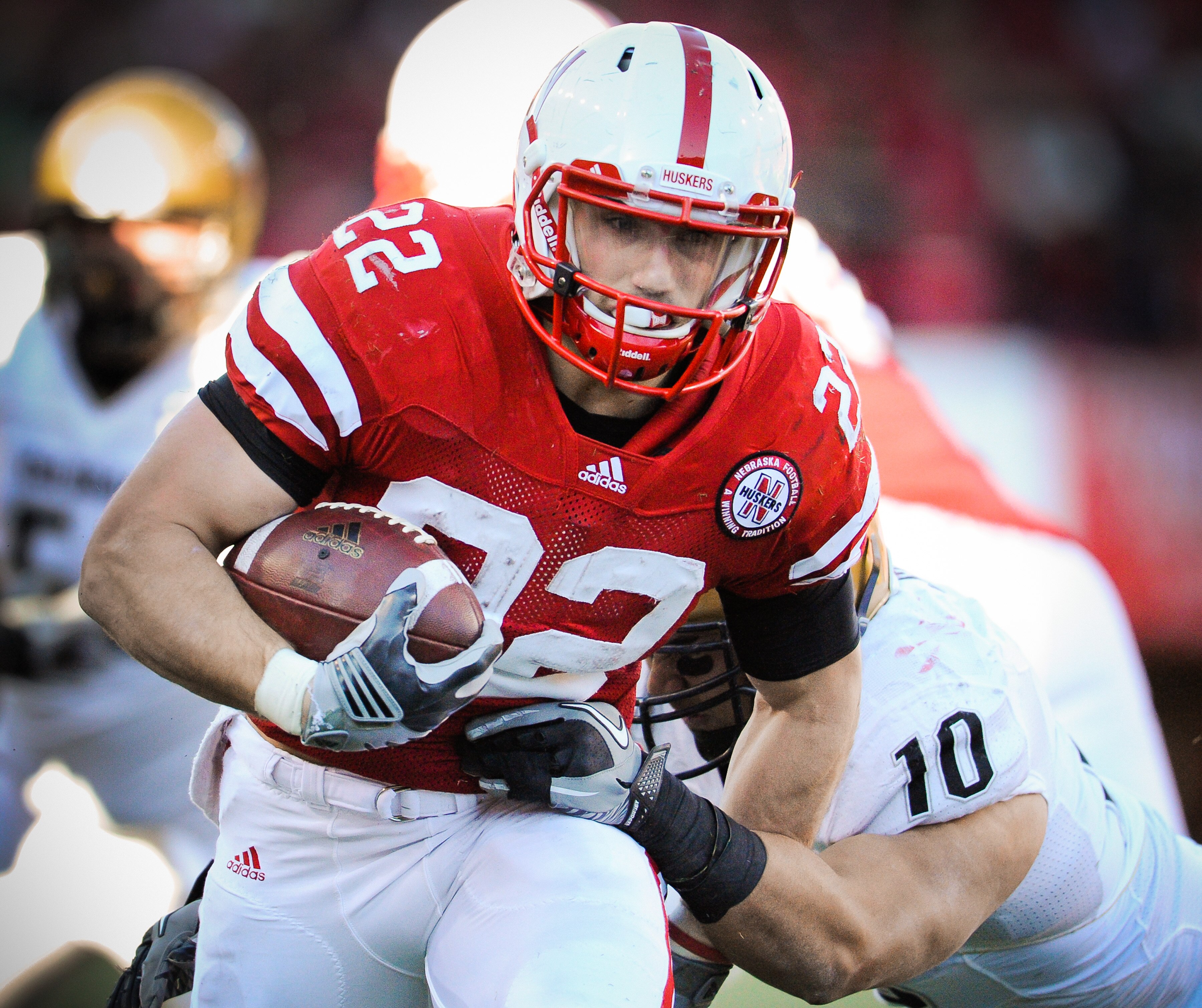 LINCOLN, NE - NOVEMBER 26: Rex Burkhead #22 of the Nebraska Cornhuskers powers through the Colorado Buffalo defense during their game at Memorial Stadium on November 26, 2010 in Lincoln, Nebraska. Nebraska defeated Colorado 45-17 (Photo by Eric Francis/Ge