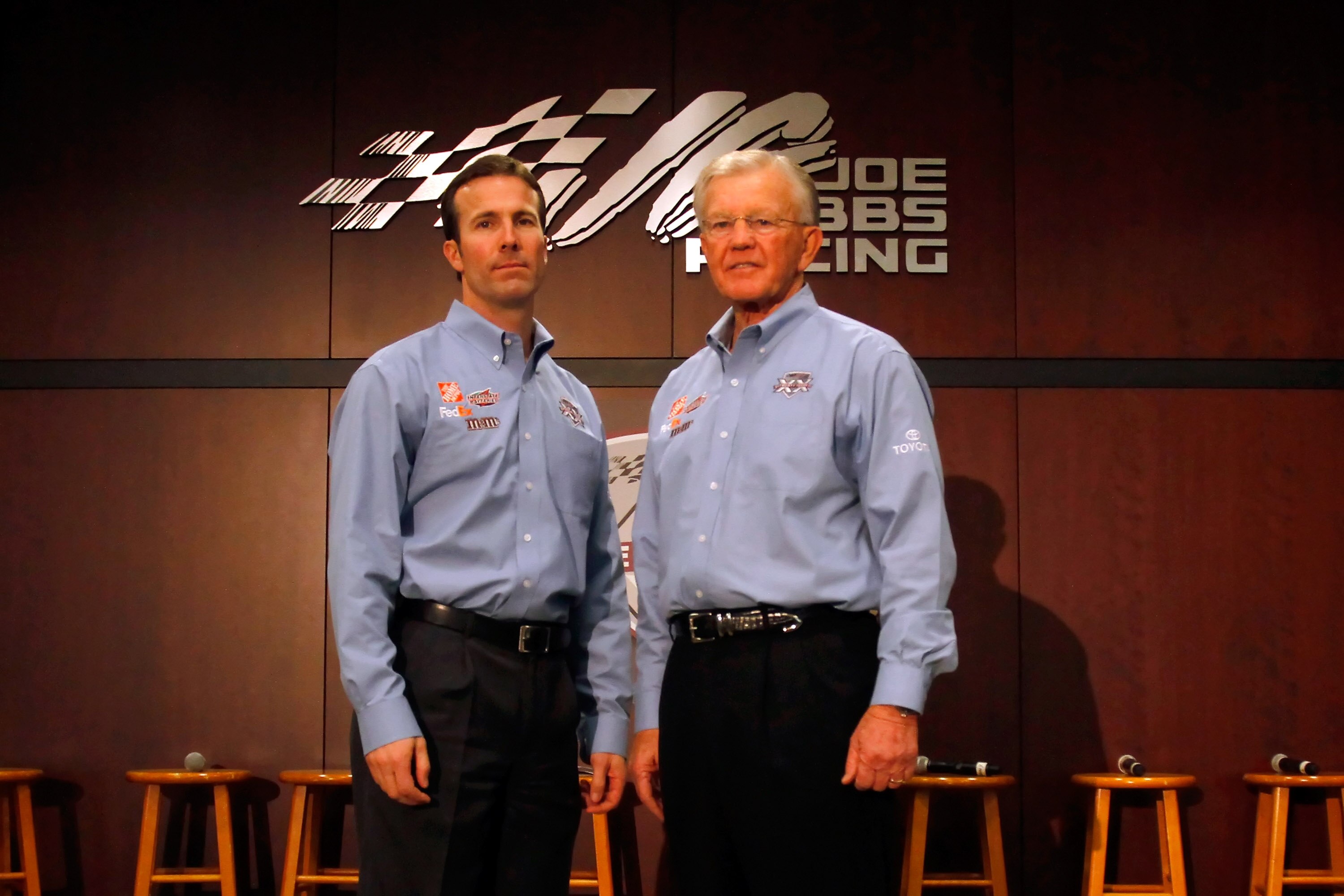 HUNTERSVILLE, NC - JANUARY 27:  Joe Gibbs (R) poses with JGR President J.D. Gibbs (L) during the NASCAR Sprint Media Tour hosted by Charlotte Motor Speedway, held at Joe Gibbs Racing, on January 27, 2011 in Huntersville, North Carolina.  (Photo by Jason S
