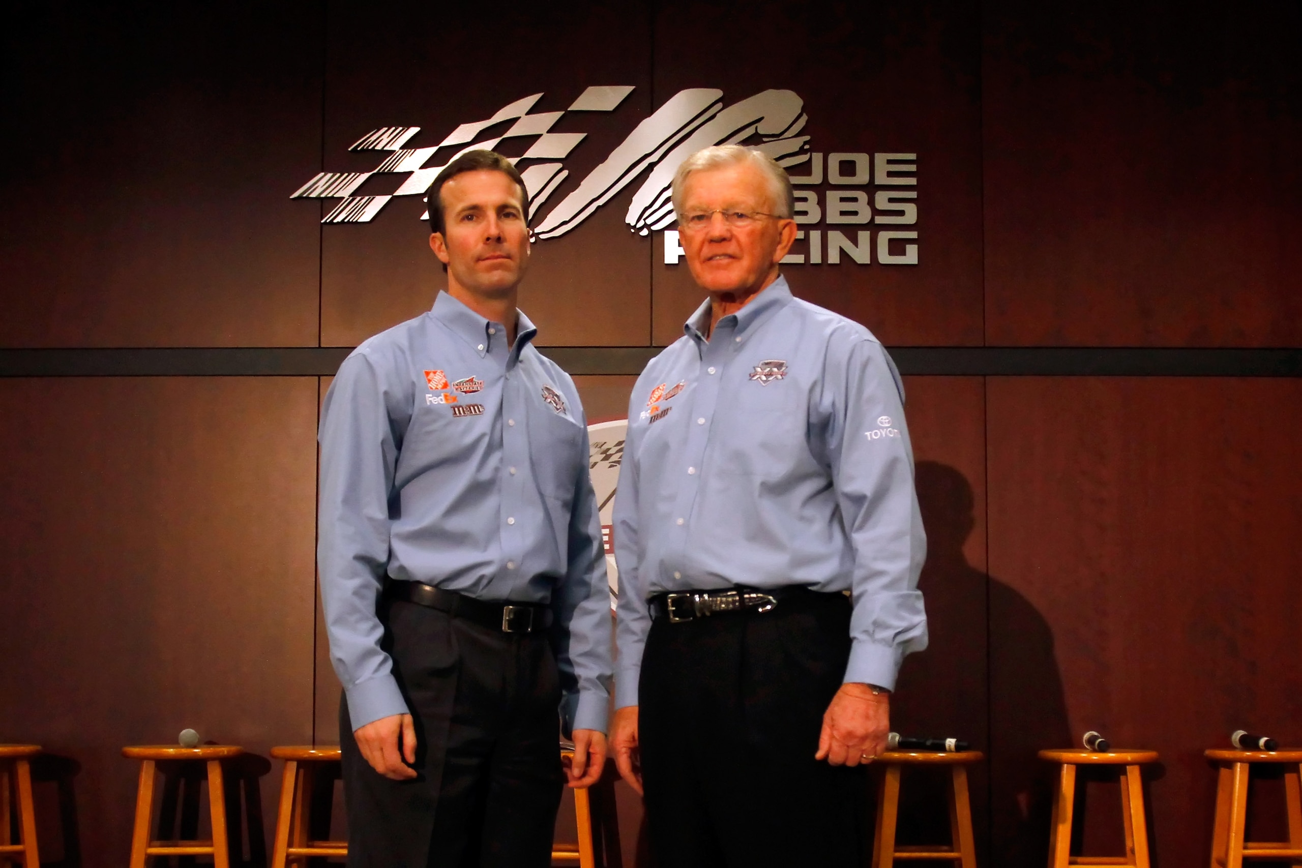 HUNTERSVILLE, NC - JANUARY 27:  Joe Gibbs (R) poses with JGR President J.D. Gibbs (L) during the NASCAR Sprint Media Tour hosted by Charlotte Motor Speedway, held at Joe Gibbs Racing, on January 27, 2011 in Huntersville, North Carolina.  (Photo by Jason S
