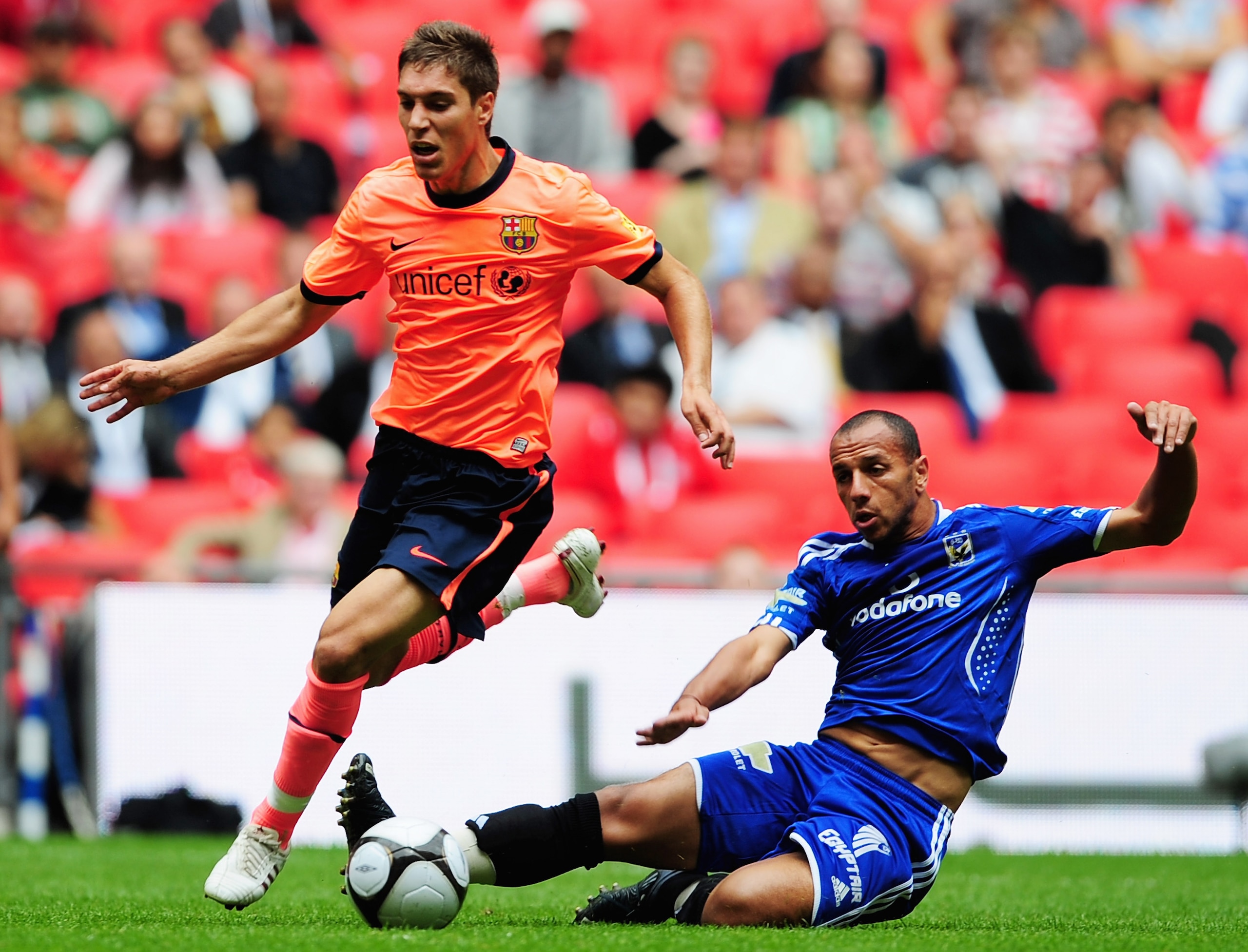LONDON, ENGLAND - JULY 26: Ruben Rochina of Barcelona is challenged by Moataz Eno of Al Ahly during the Wembley Cup match between Barcelona and Al Ahly at Wembley Stadium on July 26, 2009 in London, England. (Photo by Shaun Botterill/Getty Images) LONDON, ENGLAND - JULY 26: Ruben Rochina of Barcelona is challenged by Moataz Eno of Al Ahly during the Wembley Cup match between Barcelona and Al Ahly at Wembley Stadium on July 26, 2009 in London, England. (Photo by Shaun Botterill/Getty Images)