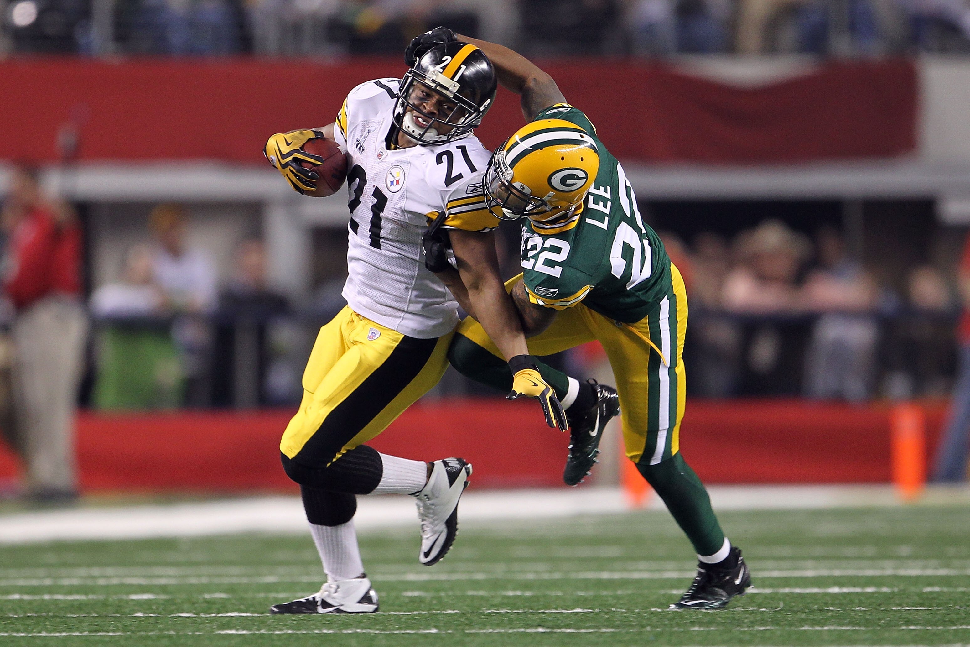 ARLINGTON, TX - FEBRUARY 06:  Mewelde Moore #21 of the Pittsburgh Steelers is tackled by Pat Lee #22 of the Green Bay Packers during Super Bowl XLV at Cowboys Stadium on February 6, 2011 in Arlington, Texas.  (Photo by Jamie Squire/Getty Images)
