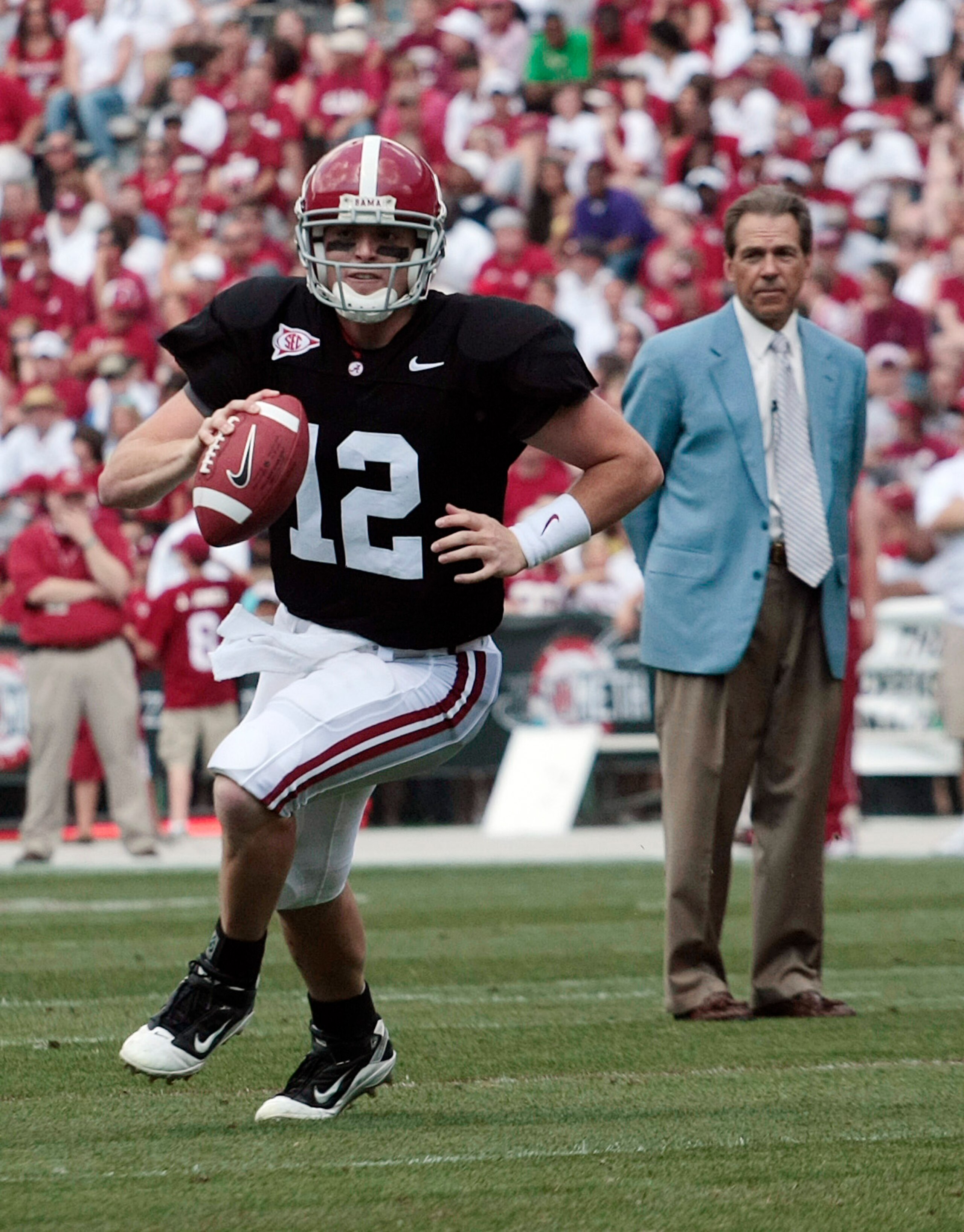 TUSCALOOSA, AL - APRIL 17: Quarterback Greg McElroy #12 of the University of Alabama looks for a receiver as coach Nick Saban looks on during the Alabama spring game at Bryant Denny Stadium on April 17, 2010 in Tuscaloosa, Alabama. (Photo by Dave Martin/G