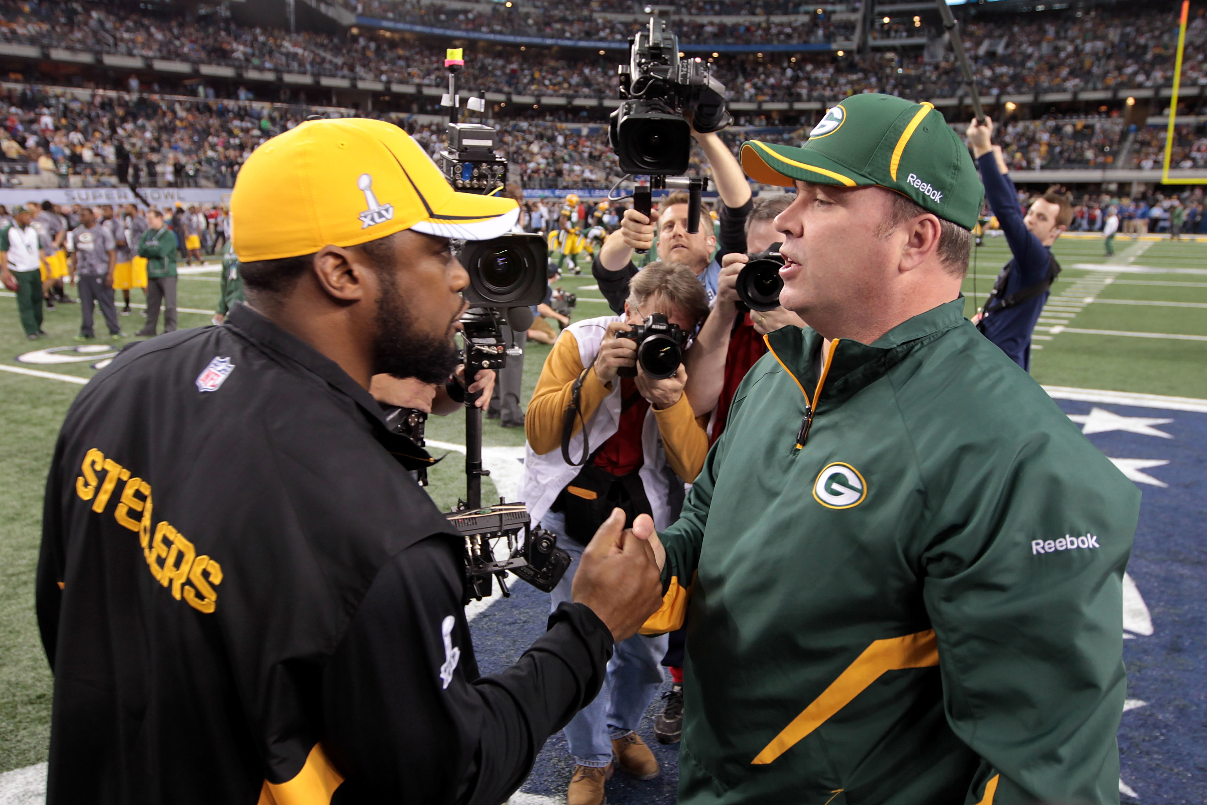 ARLINGTON, TX - FEBRUARY 06: Head coach Mike Tomlin of the Pittsburgh Steelers and head coach Mike McCarthy of the Green Bay Packers speak prior to Super Bowl XLV at Cowboys Stadium on February 6, 2011 in Arlington, Texas.  (Photo by Jamie Squire/Getty Im