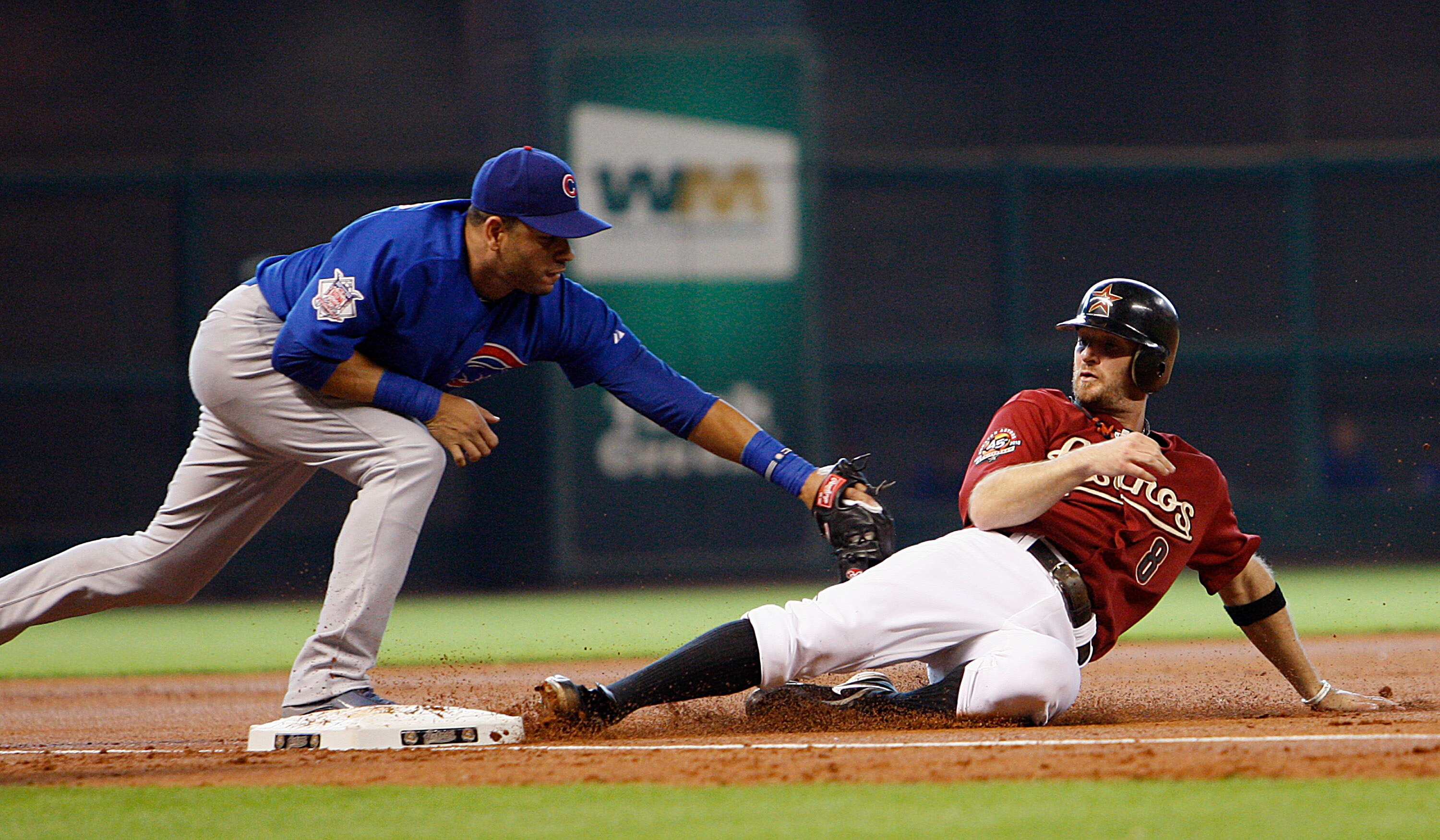 HOUSTON - JUNE 06:  Jeff Keppinger #8 of the Houston Astros is tagged out at third base by Aramis Ramirez #16 of the Chicago Cubs in the first inning at Minute Maid Park on June 6, 2010 in Houston, Texas.  (Photo by Bob Levey/Getty Images)