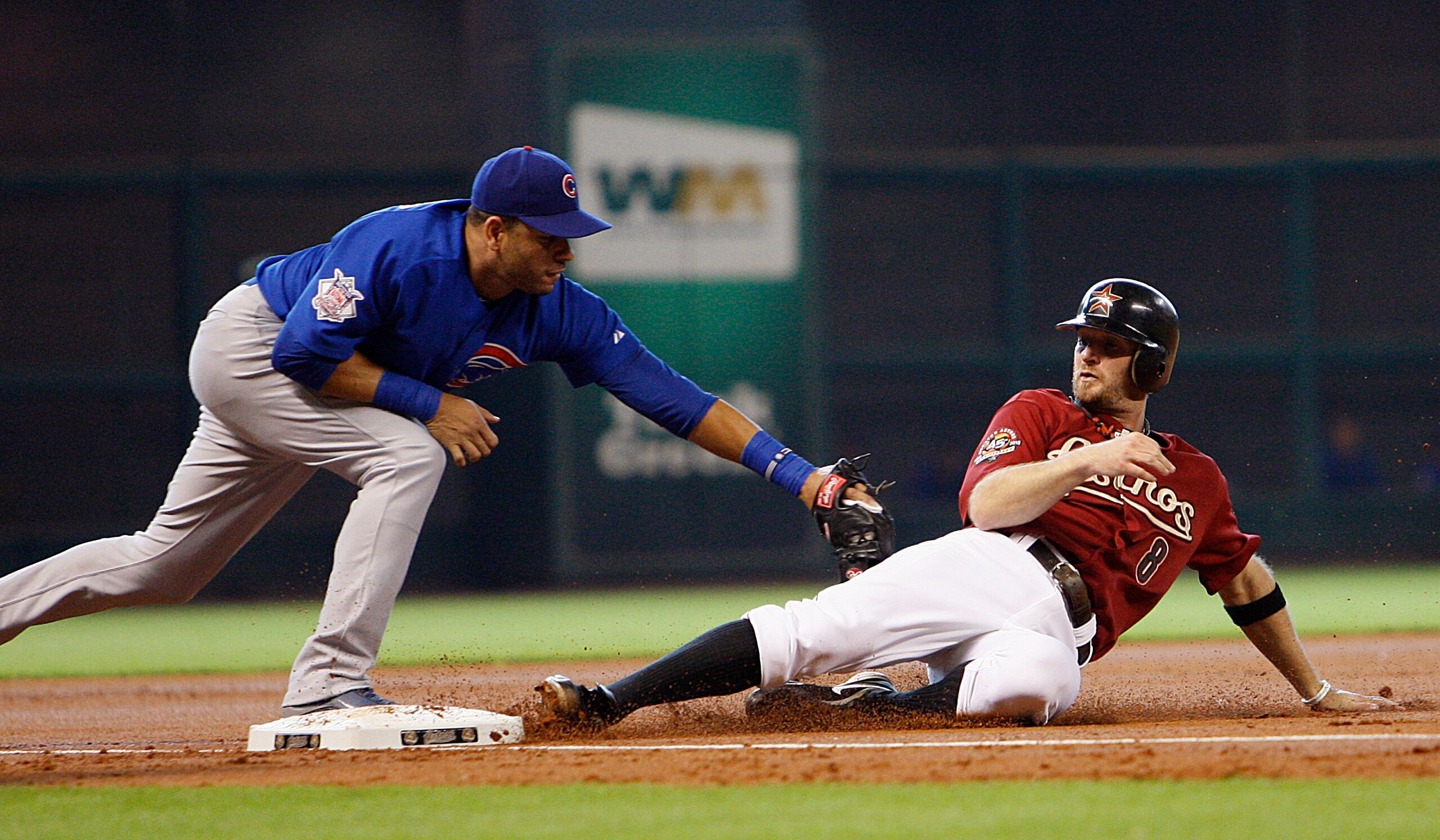 HOUSTON - JUNE 06:  Jeff Keppinger #8 of the Houston Astros is tagged out at third base by Aramis Ramirez #16 of the Chicago Cubs in the first inning at Minute Maid Park on June 6, 2010 in Houston, Texas.  (Photo by Bob Levey/Getty Images)