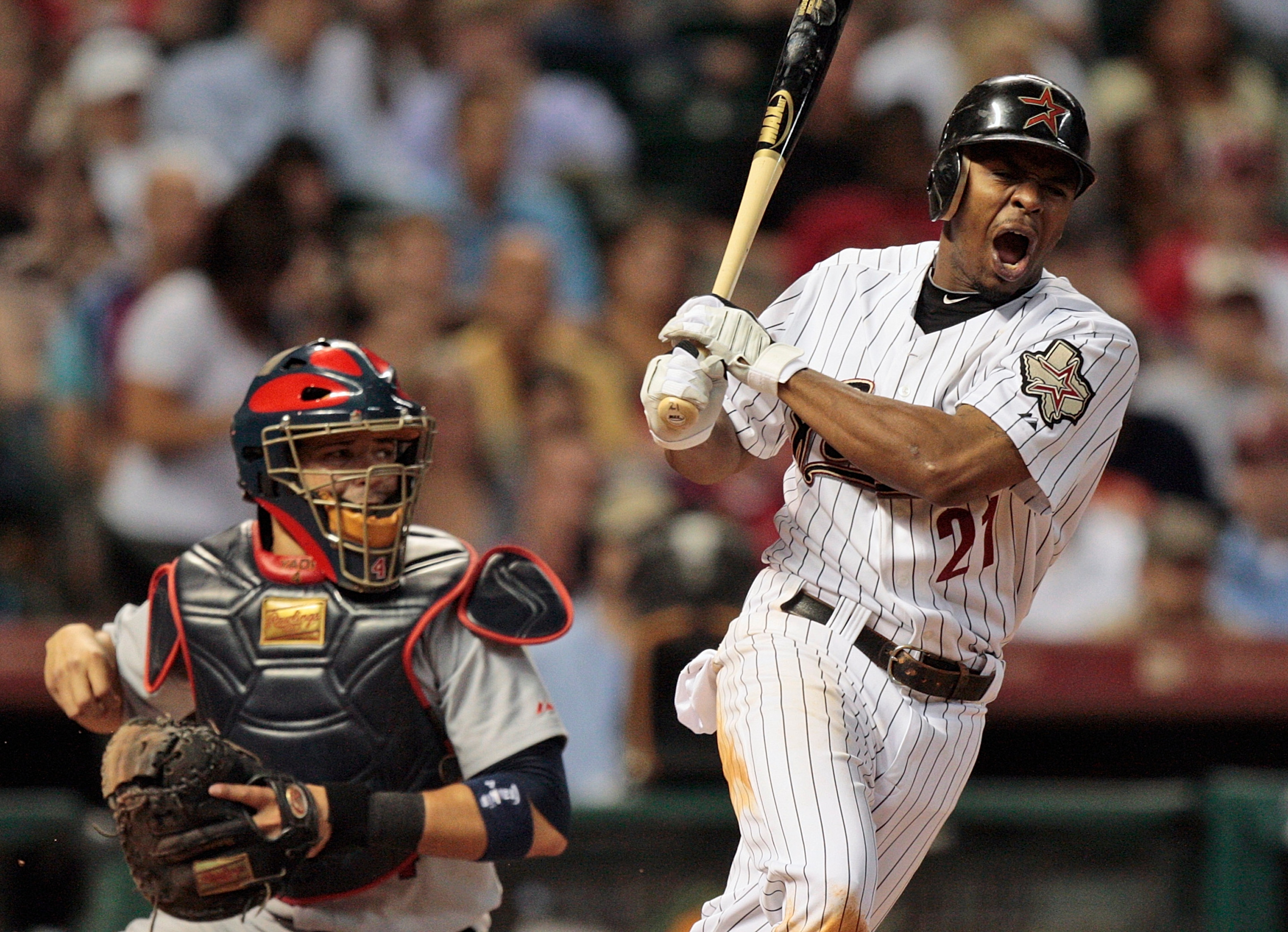 HOUSTON - AUGUST 31:  Michael Bourn #21 of the Houston Astros reacts after fouling a ball off his foot as catcher Yadier Molina #4 of the St. Louis Cardinals watches at Minute Maid Park on August 31, 2010 in Houston, Texas.  (Photo by Bob Levey/Getty Imag