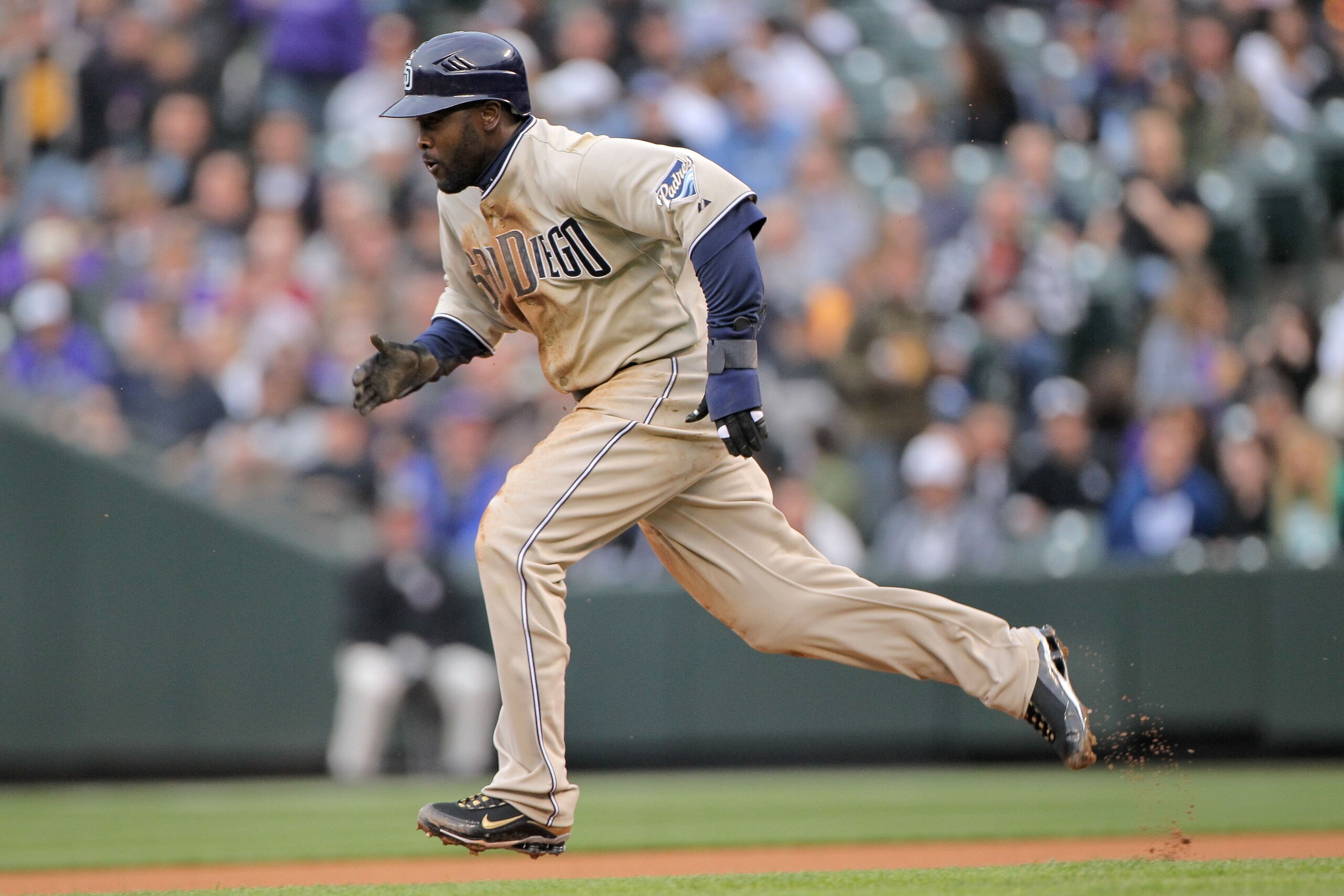 DENVER - APRIL 10: Centerfielder Tony Gwynn Jr. #18 of the San Diego Padres steals secondbase against starting pitcher Jason Hammel of the Colorado Rockies during MLB action at Coors Field on April 10, 2010 in Denver, Colorado. The Padres defeated the Ro DENVER - APRIL 10: Centerfielder Tony Gwynn Jr. #18 of the San Diego Padres steals secondbase against starting pitcher Jason Hammel of the Colorado Rockies during MLB action at Coors Field on April 10, 2010 in Denver, Colorado. The Padres defeated the Ro