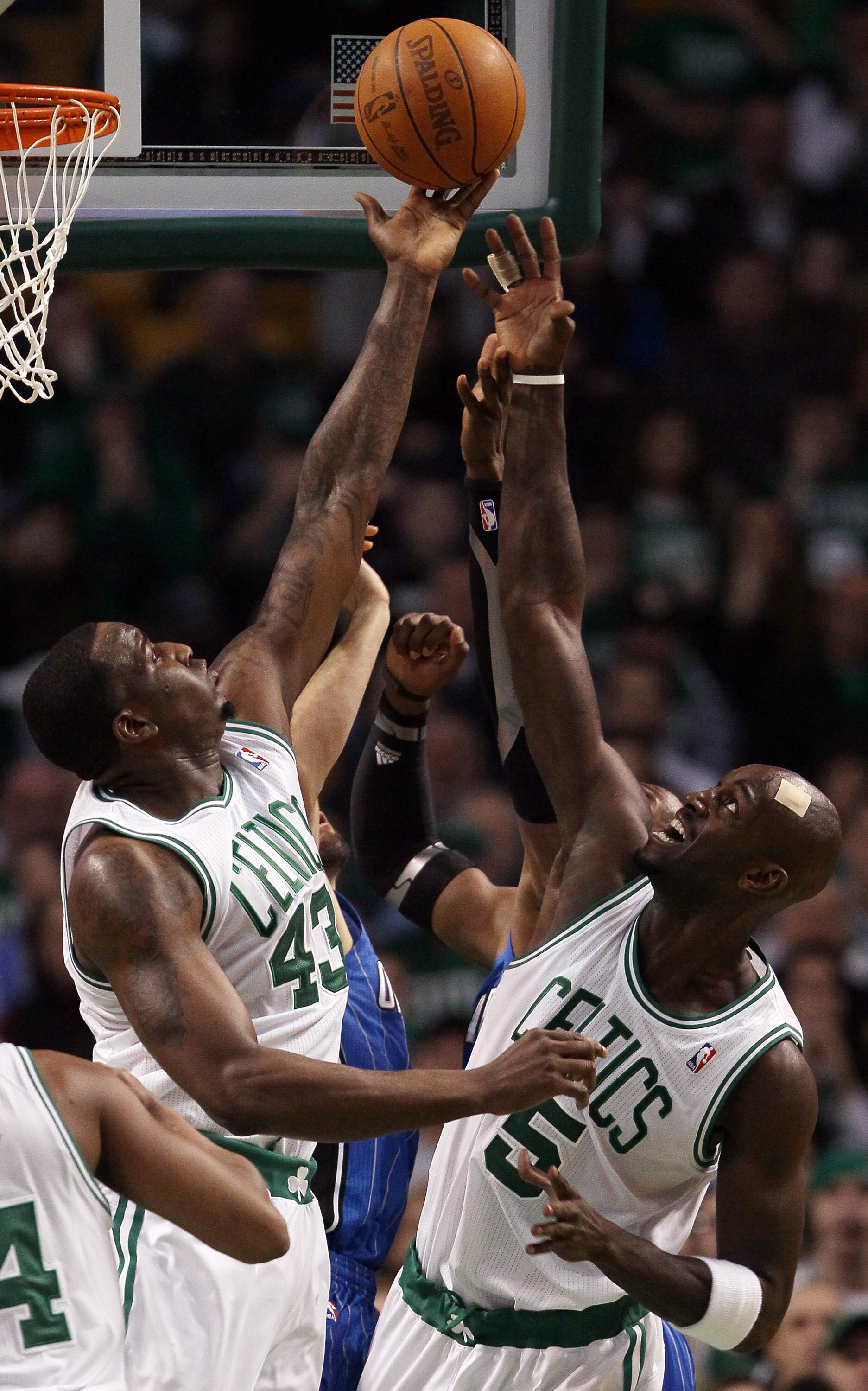 BOSTON, MA - FEBRUARY 06:  Kendrick Perkins #43 and Kevin Garnett #5 of the Boston Celtics fight for the rebound with Dwight Howard #12 of the Orlando Magic on February 6, 2011 at the TD Garden in Boston, Massachusetts. The Celtics defeated the Magic 91-8