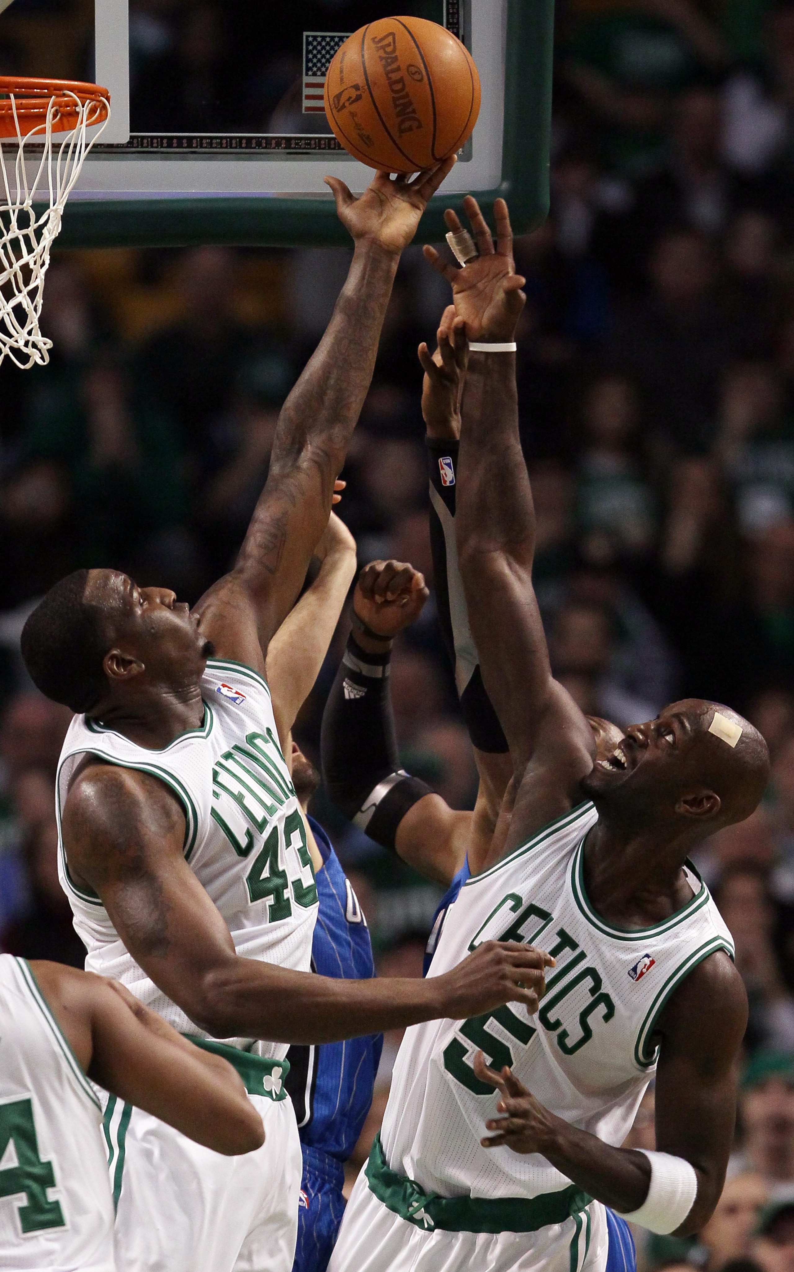 BOSTON, MA - FEBRUARY 06: Kendrick Perkins #43 and Kevin Garnett #5 of the Boston Celtics fight for the rebound with Dwight Howard #12 of the Orlando Magic on February 6, 2011 at the TD Garden in Boston, Massachusetts. The Celtics defeated the Magic 91-8 BOSTON, MA - FEBRUARY 06: Kendrick Perkins #43 and Kevin Garnett #5 of the Boston Celtics fight for the rebound with Dwight Howard #12 of the Orlando Magic on February 6, 2011 at the TD Garden in Boston, Massachusetts. The Celtics defeated the Magic 91-8