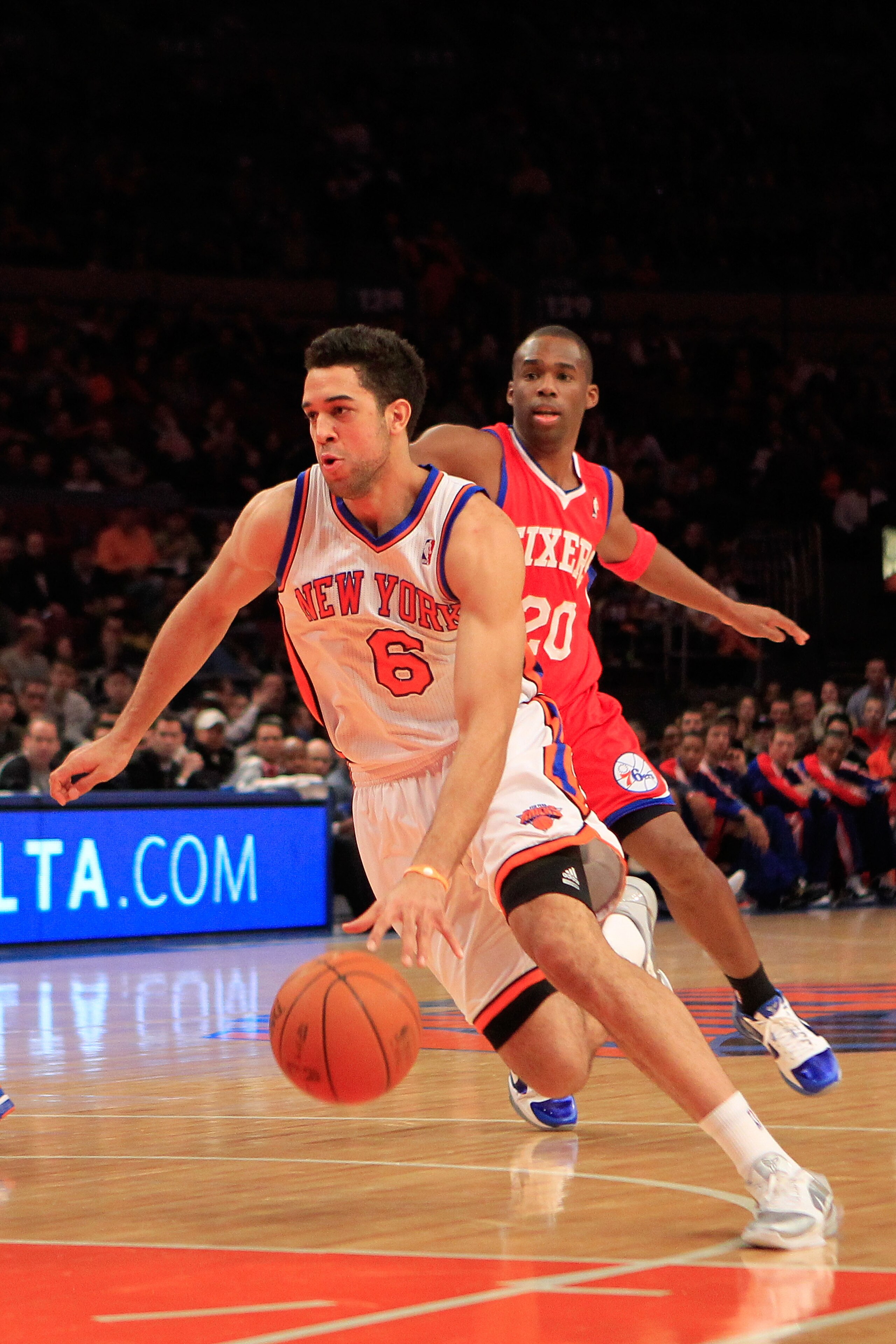 NEW YORK, NY - FEBRUARY 06:  Landry Fields #6 of the New York Knicks drives past Jodie Meeks #20 of the Philadelphia 76ers at Madison Square Garden on February 6, 2011 in New York City. NOTE TO USER: User expressly acknowledges and agrees that, by downloa