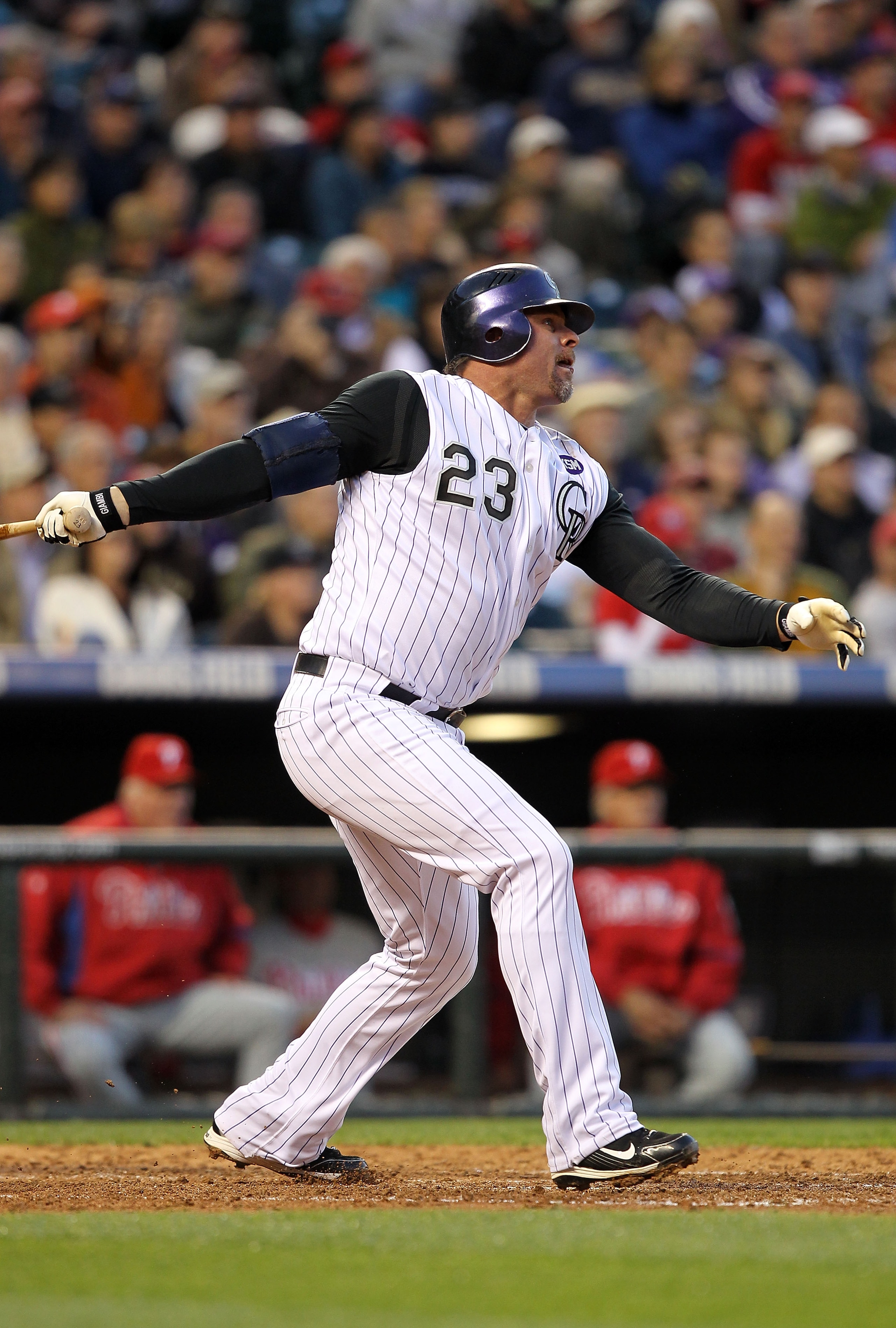 DENVER - MAY 10:  Jason Giambi #23 of the Colorado Rockies hits a sacrfice fly in the third inning to score Seth Smith against the Philadelphia Phillies at Coors Field on May 10, 2010 in Denver, Colorado.  (Photo by Doug Pensinger/Getty Images)