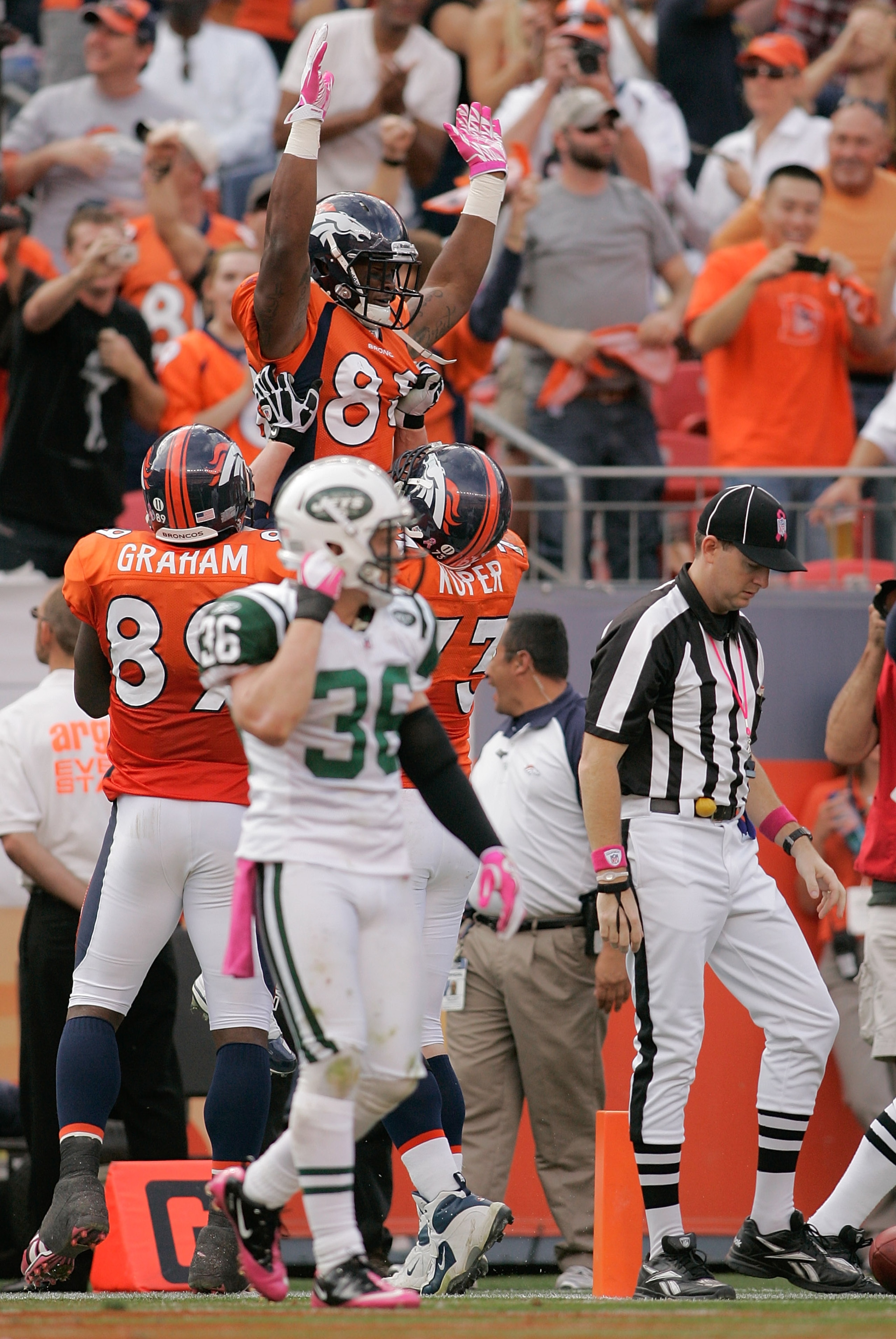 DENVER - OCTOBER 17: Wide receiver Demaryius Thomas #88 of the Denver Broncos celebrates his touchdown with teammates Daniel Graham #89 and Chris Kuper #73 as safety Jim Leonhard #36 the New York Jets walks off at INVESCO Field at Mile High on October 17 DENVER - OCTOBER 17: Wide receiver Demaryius Thomas #88 of the Denver Broncos celebrates his touchdown with teammates Daniel Graham #89 and Chris Kuper #73 as safety Jim Leonhard #36 the New York Jets walks off at INVESCO Field at Mile High on October 17