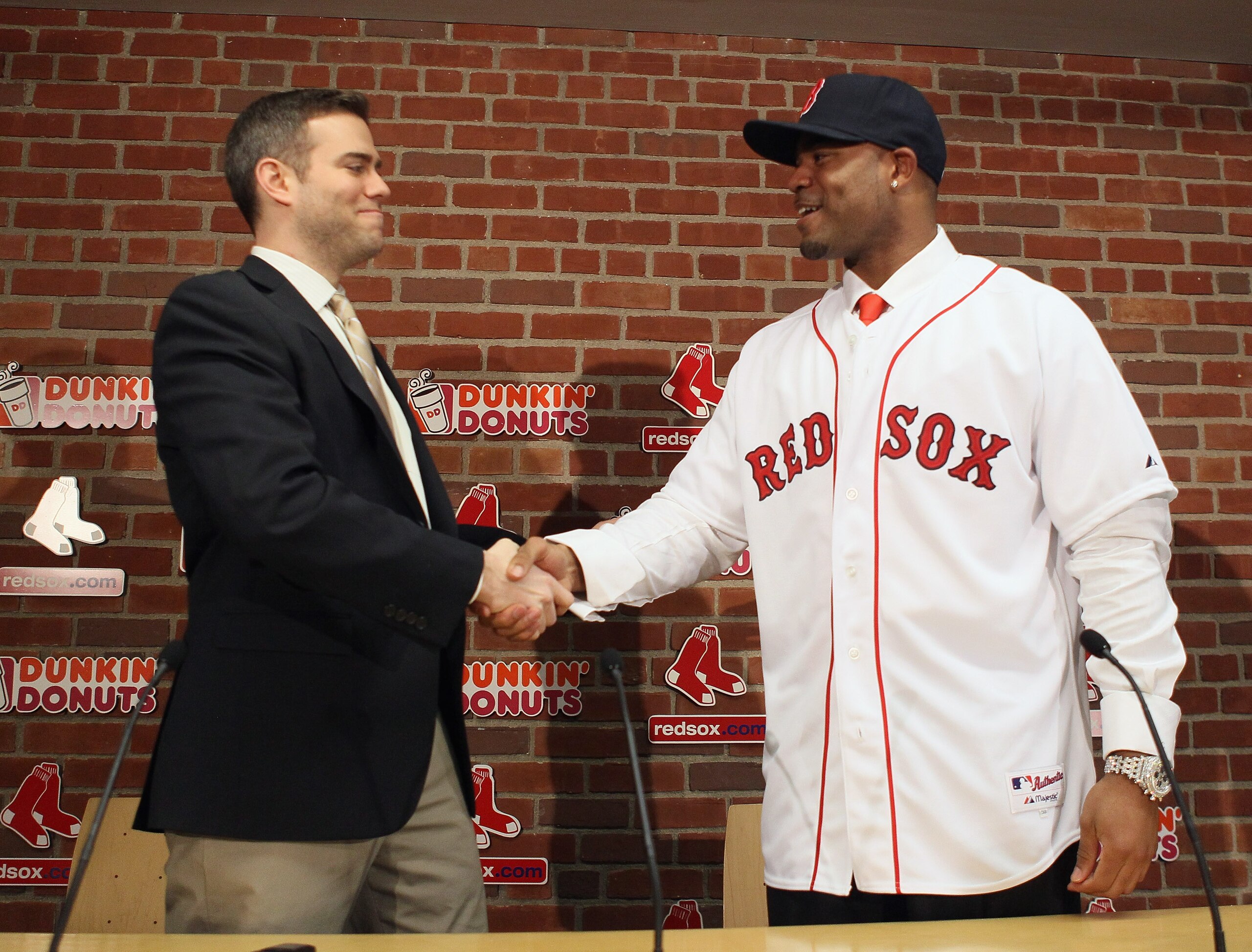 BOSTON, MA - DECEMBER 11:  Theo Epstein (L), general manager of the Boston Red Sox, welcomes Carl Crawford to the team during a press conference to announce Crawford's signing on December 11,  2010 at the Fenway Park in Boston, Massachusetts.  (Photo by E