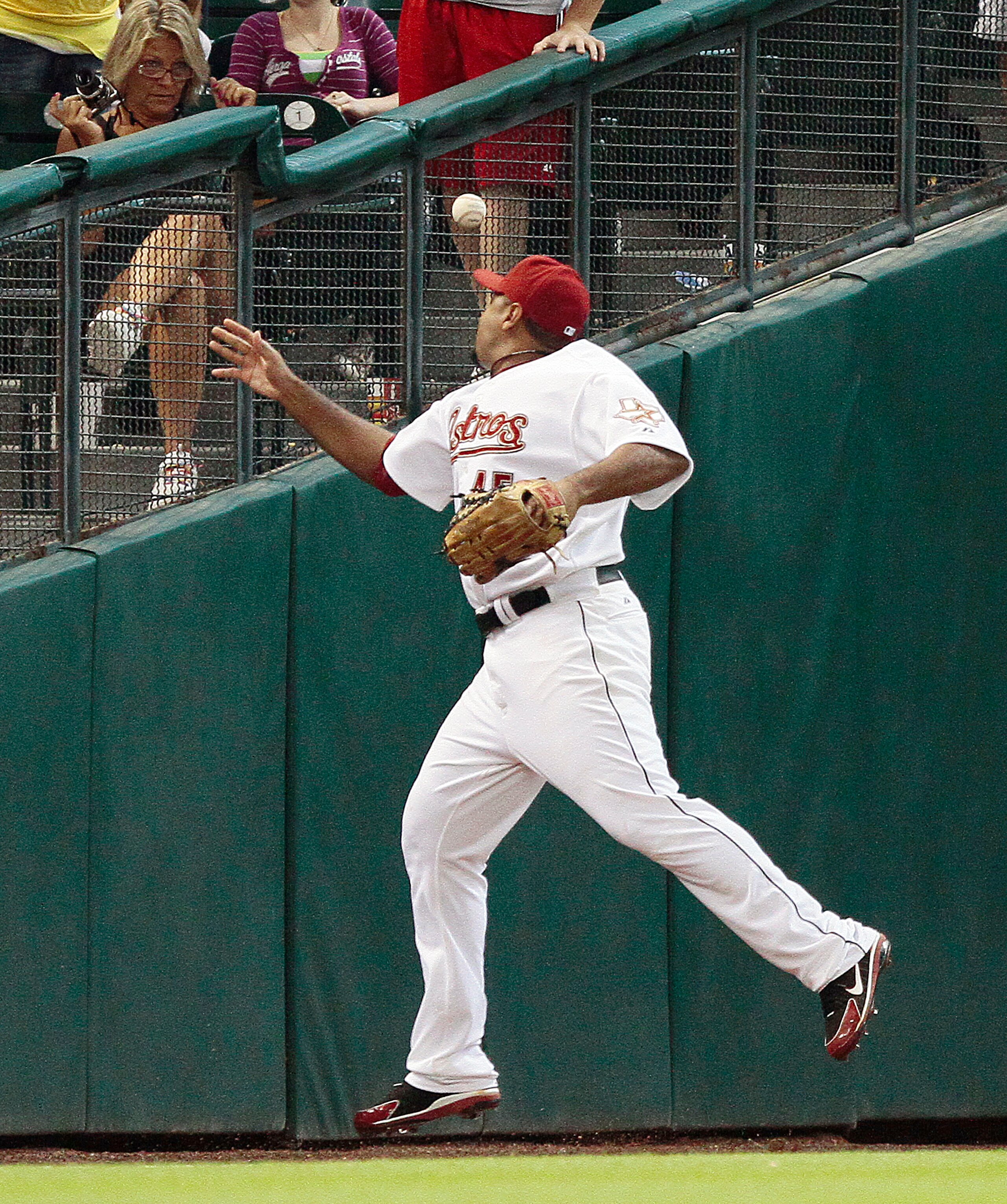HOUSTON - JUNE 03:  Left fielder Carlos Lee #45 of the Houston Astros misplays a ball hit by Willie Harris of the Washington Nationals in the ninth inning scoring Mike Morse at Minute Maid Park on June 3, 2010 in Houston, Texas.  (Photo by Bob Levey/Getty