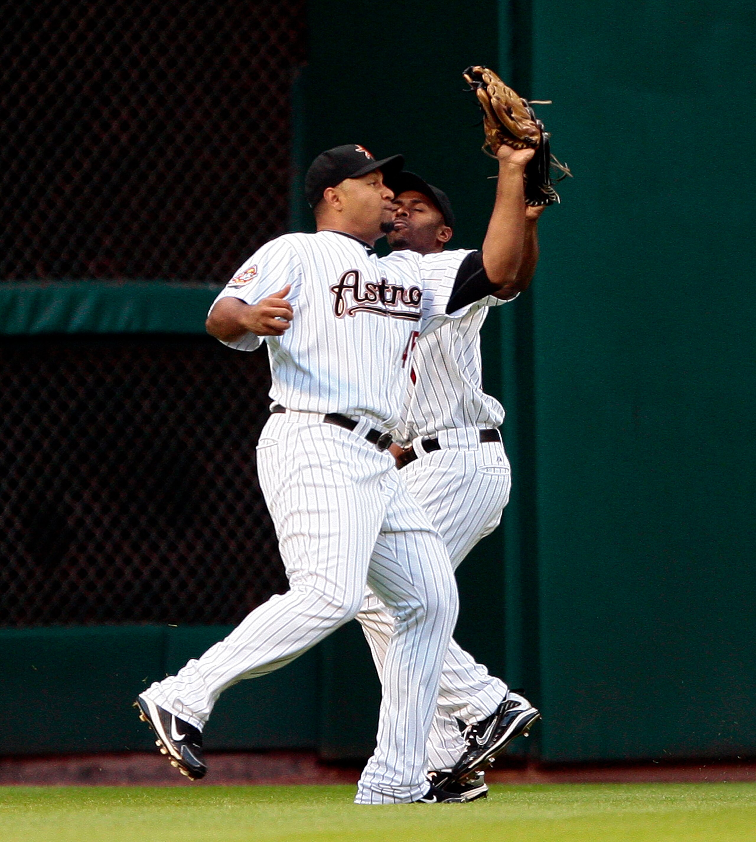 HOUSTON - MAY 19:  Left fielder Carlos Lee #45 of the Houston Astros avoids colliding with Michael Bourn #21 as he holds onto the ball against the Colorado Rockies at Minute Maid Park on May 19, 2010 in Houston, Texas.  (Photo by Bob Levey/Getty Images)