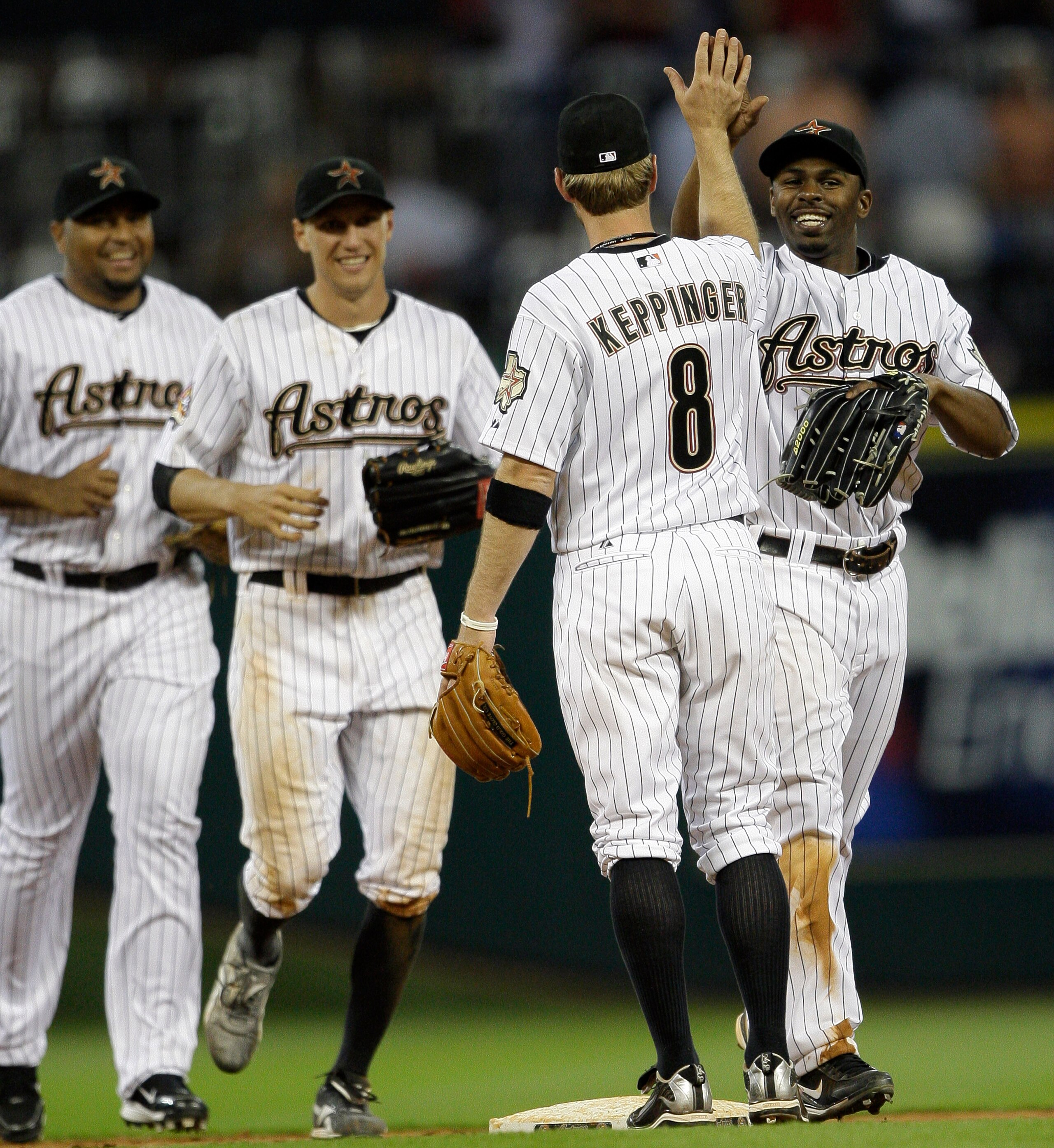 HOUSTON - APRIL 20:  Jeff Keppinger #8 of the Houston Astros receives a high five from Michael Bourn after the Houston Astros defeated the Florida Marlins 7-5 at Minute Maid Park on April 20, 2010 in Houston, Texas.  (Photo by Bob Levey/Getty Images)
