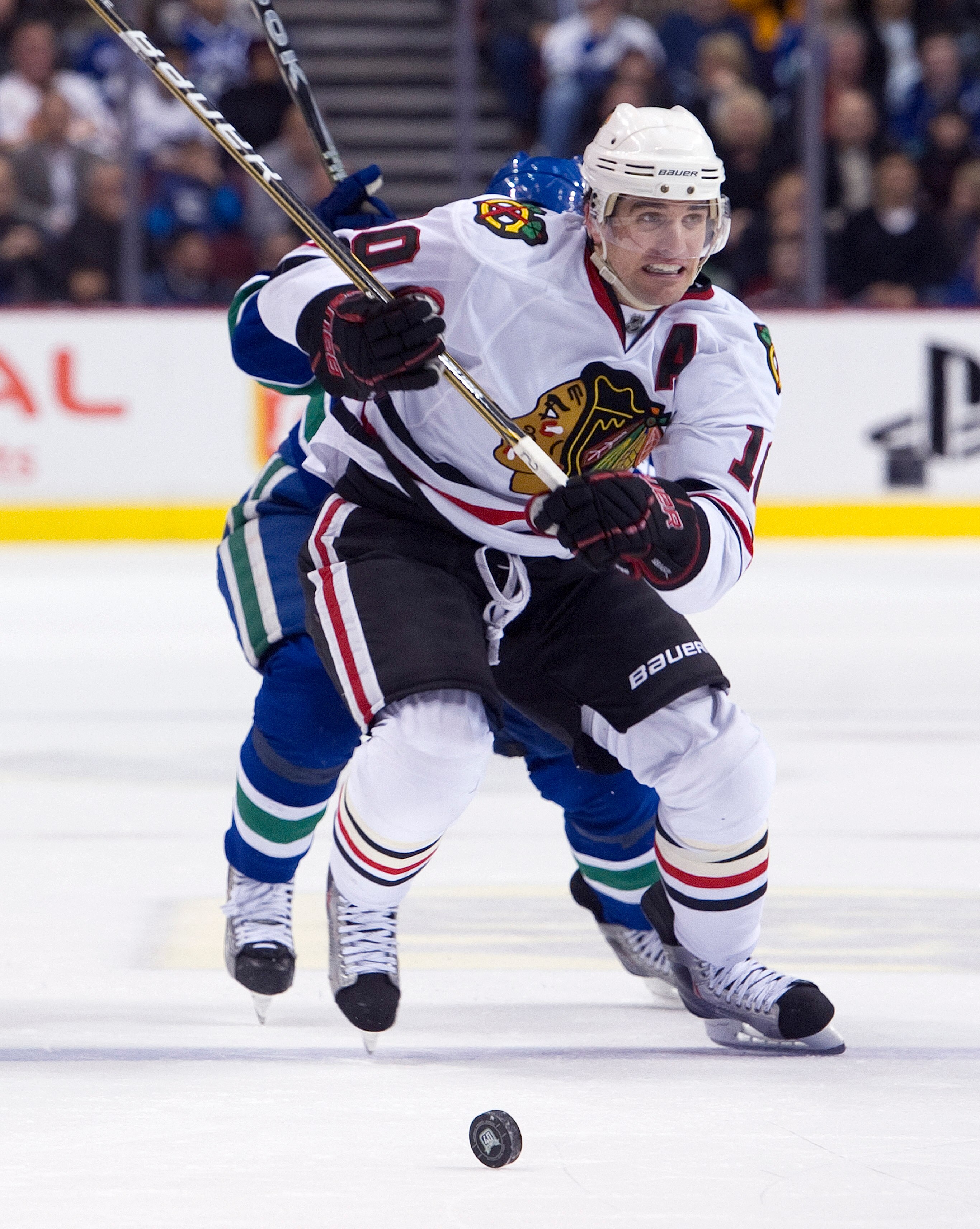 VANCOUVER, CANADA - JANUARY 4: Patrick Sharp #10 of the Chicago Blackhawks chases the loose puck with Cody Hodgson #39 of the Vancouver Canucks in pursuit during the third period in NHL action on February 04, 2011 at Rogers Arena in Vancouver, British Col
