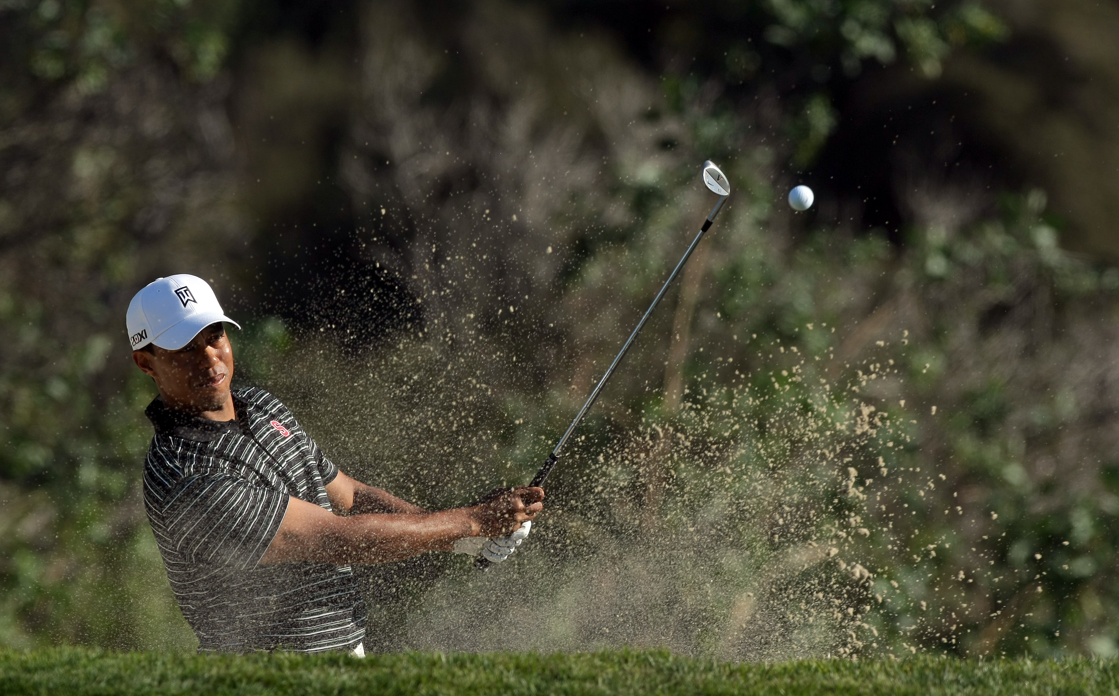 LA JOLLA, CA - JANUARY 29: Tiger Woods hits out of the bunker on the 16th hole during Round 3 of the Farmers Insurance Open at Torrey Pines on January 29, 2011 in La Jolla, California. (Photo by Donald Miralle/Getty Images) LA JOLLA, CA - JANUARY 29: Tiger Woods hits out of the bunker on the 16th hole during Round 3 of the Farmers Insurance Open at Torrey Pines on January 29, 2011 in La Jolla, California. (Photo by Donald Miralle/Getty Images)