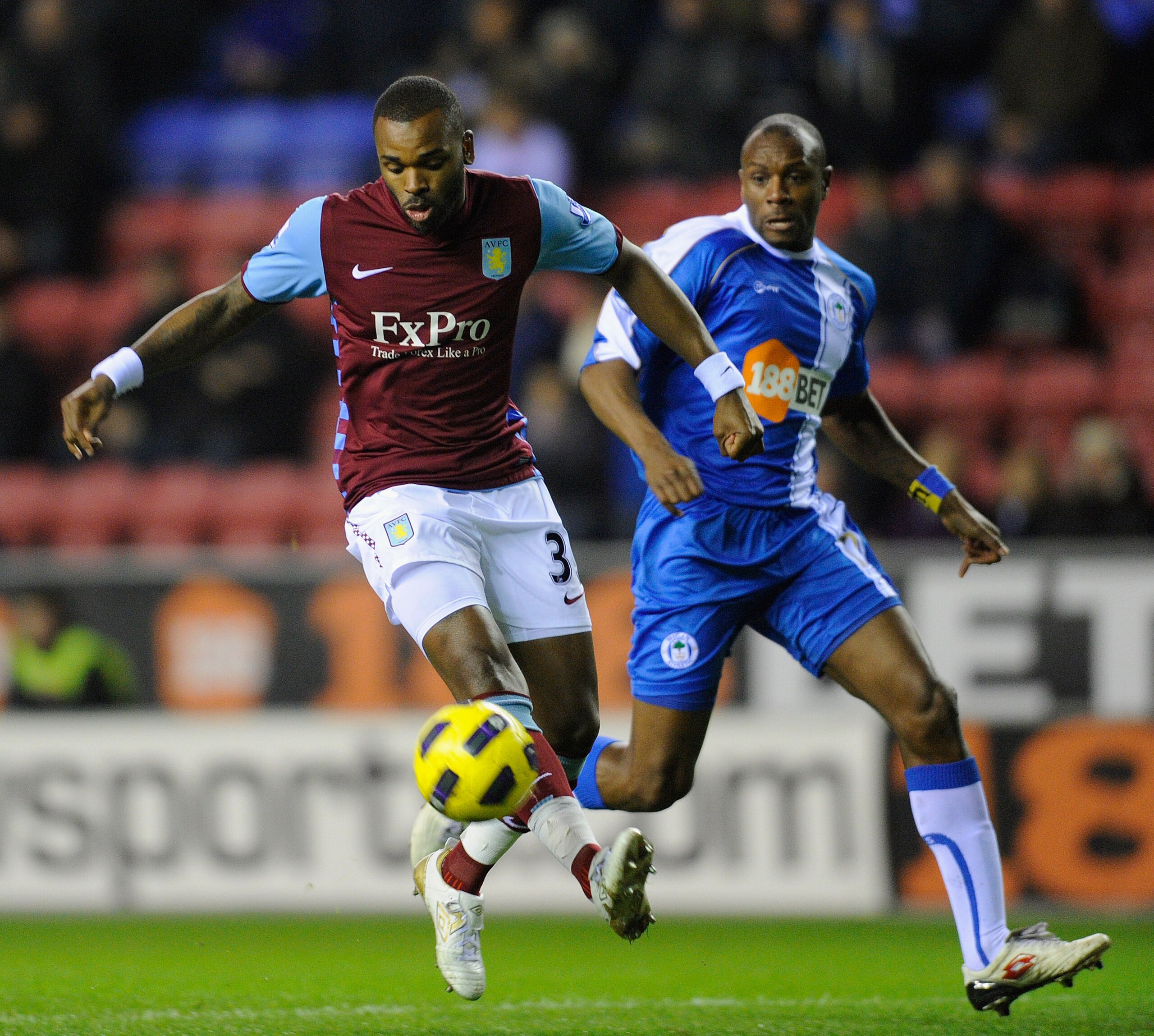 WIGAN, ENGLAND - JANUARY 25: Darren Bent of Aston Villa controls the ball ahead of Emmerson Boyce of Wigan during the Barclays Premier League match between Wigan Athletic and Aston Villa at the DW Stadium on January 25, 2011 in Wigan, England. (Photo by WIGAN, ENGLAND - JANUARY 25: Darren Bent of Aston Villa controls the ball ahead of Emmerson Boyce of Wigan during the Barclays Premier League match between Wigan Athletic and Aston Villa at the DW Stadium on January 25, 2011 in Wigan, England. (Photo by