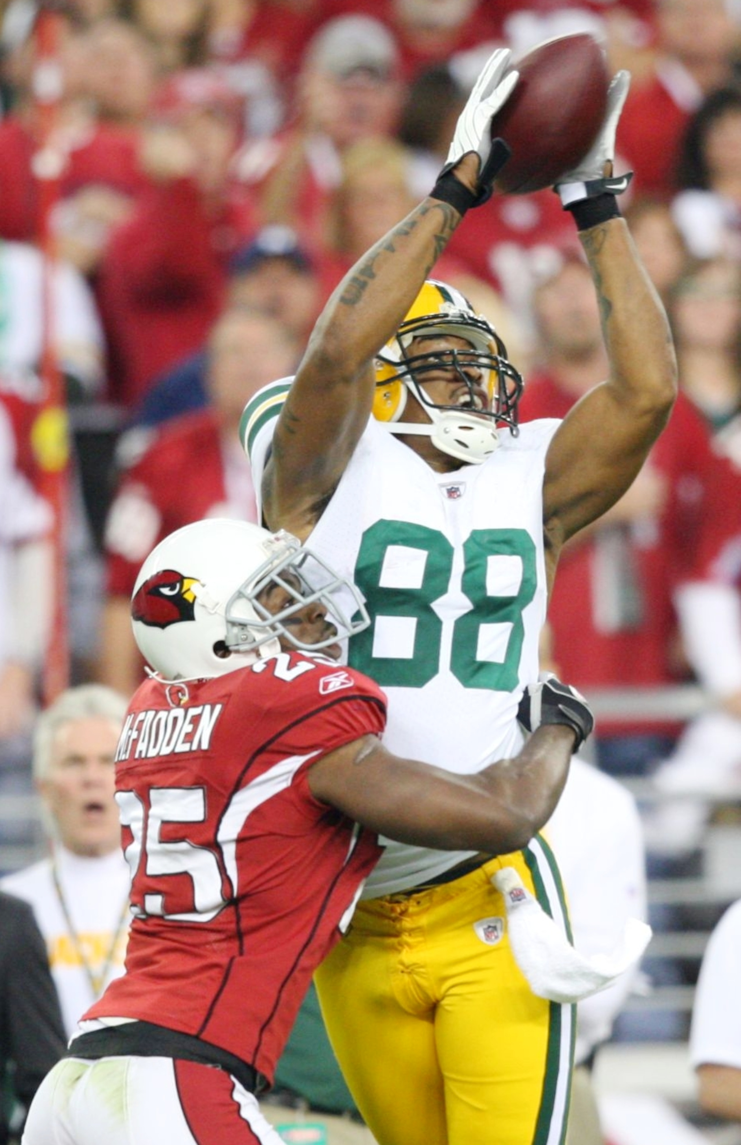 GLENDALE, AZ - JANUARY 10: Jermichael Finley #88 of the Green Bay Packers makes a 44 yard reception over Bryant McFadden #25 of the Arizona Cardinals during the second quarter of the 2010 NFC wild-card playoff game at University of Phoenix Stadium on Ja GLENDALE, AZ - JANUARY 10: Jermichael Finley #88 of the Green Bay Packers makes a 44 yard reception over Bryant McFadden #25 of the Arizona Cardinals during the second quarter of the 2010 NFC wild-card playoff game at University of Phoenix Stadium on Ja