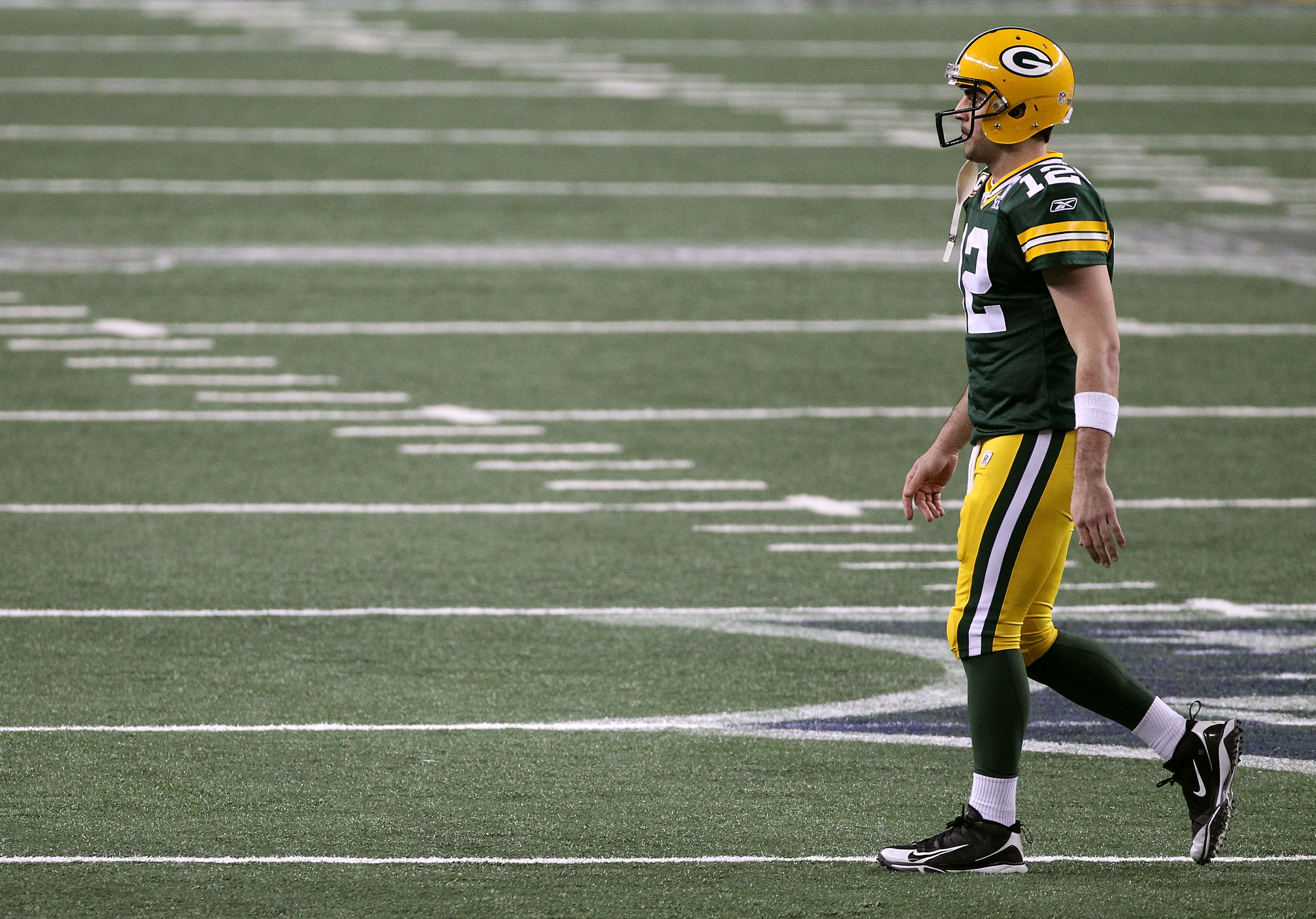 ARLINGTON, TX - FEBRUARY 06:  Aaron Rodgers #12 of the Green Bay Packers walks to the sideline after a play against the Pittsburgh Steelers during the second half of Super Bowl XLV at Cowboys Stadium on February 6, 2011 in Arlington, Texas.  (Photo by Str