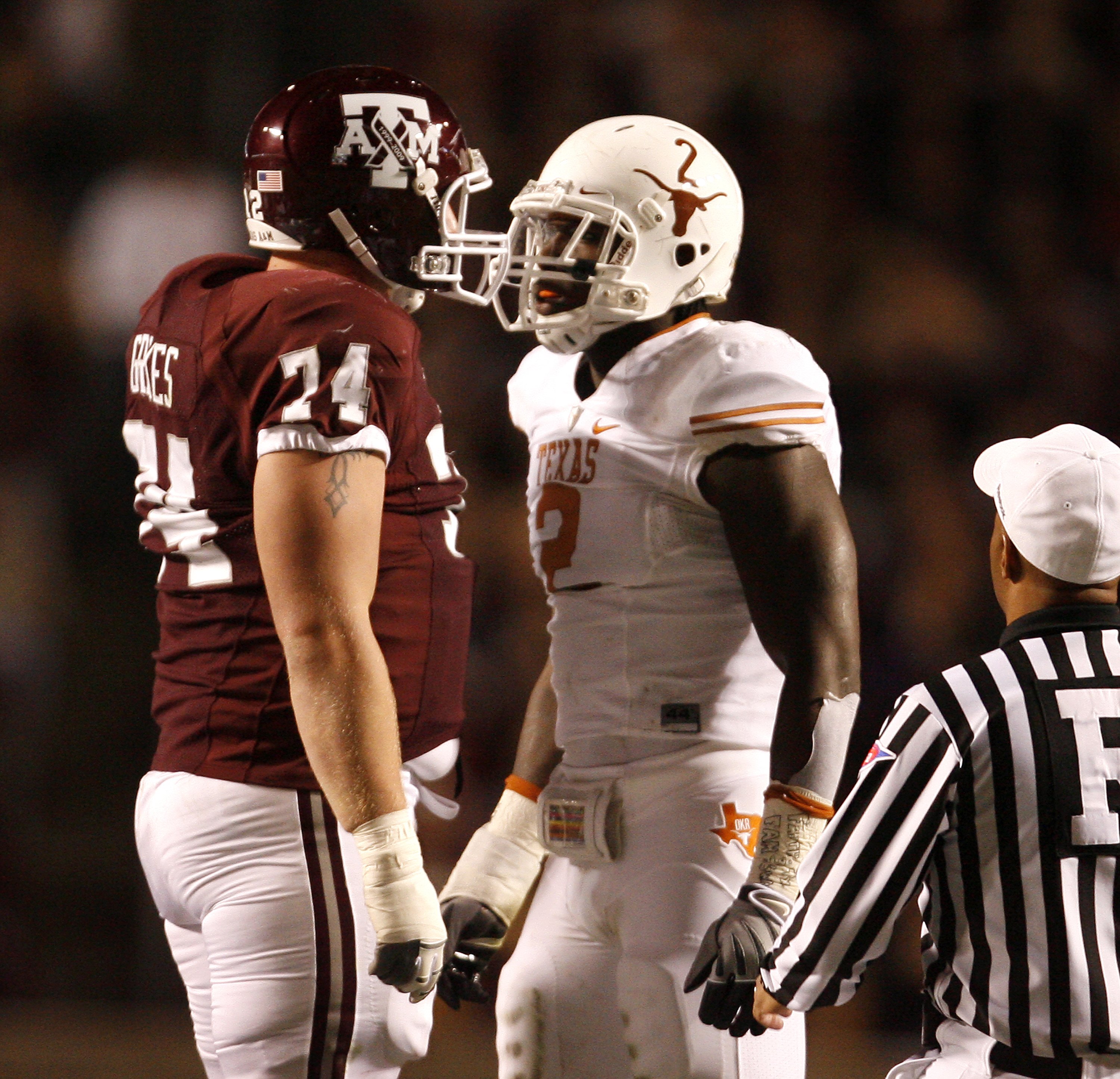 COLLEGE STATION, TX - NOVEMBER 26:  Right tackle Lee Grimes #74 of the Texas A&M Aggies confronts defensive end Sergio Kindle #2 of the Texas Longhorns in the first half at Kyle Field on November 26, 2009 in College Station, Texas. The Longhorns defeated
