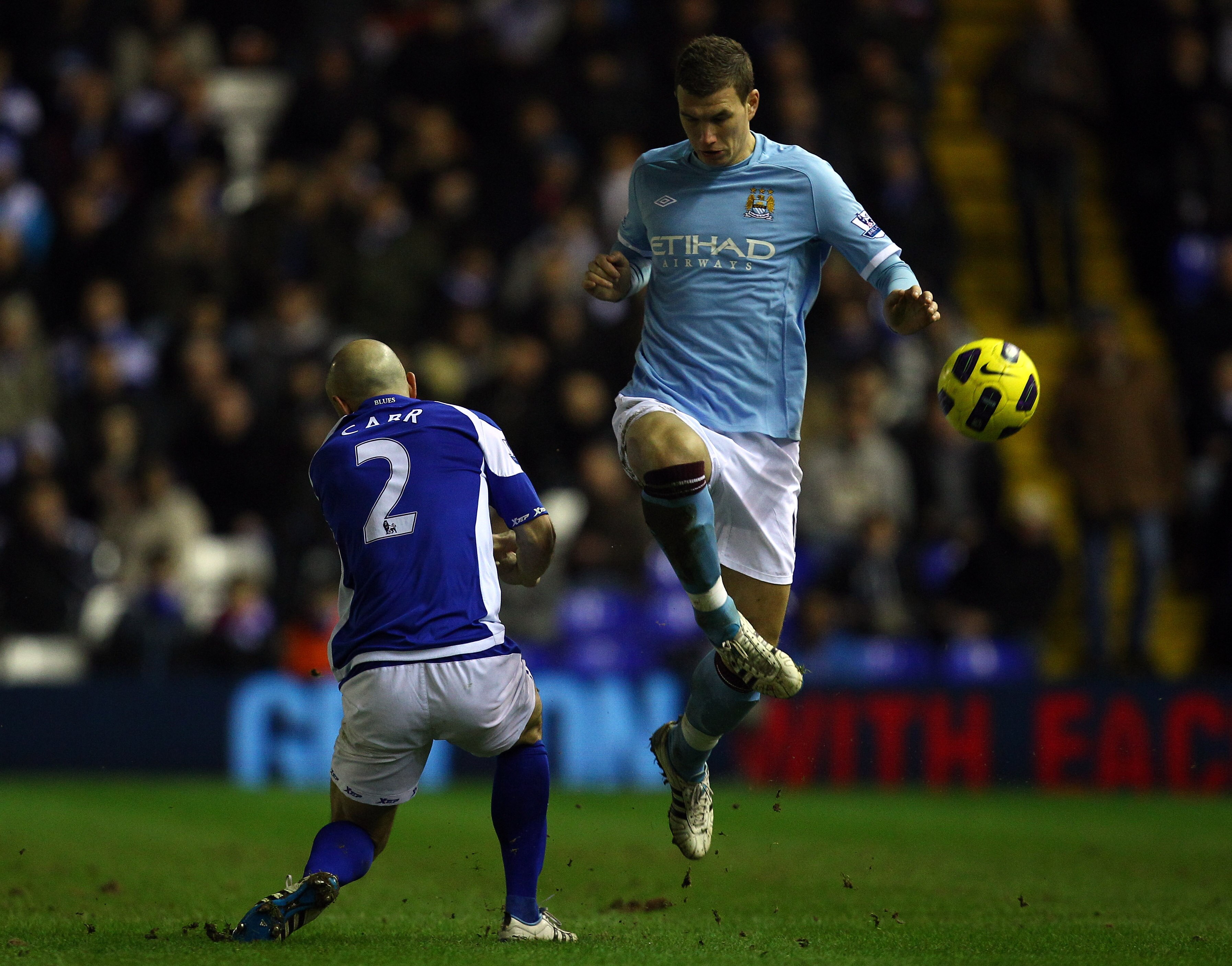 BIRMINGHAM, ENGLAND - FEBRUARY 02:  Edin Dzeko  of Manchester City goes past Stephen Carr of Birmingham during the Barclays premier league match between Birmingham City and Manchester City at St Andrews on February 2, 2011 in Birmingham, England.  (Photo