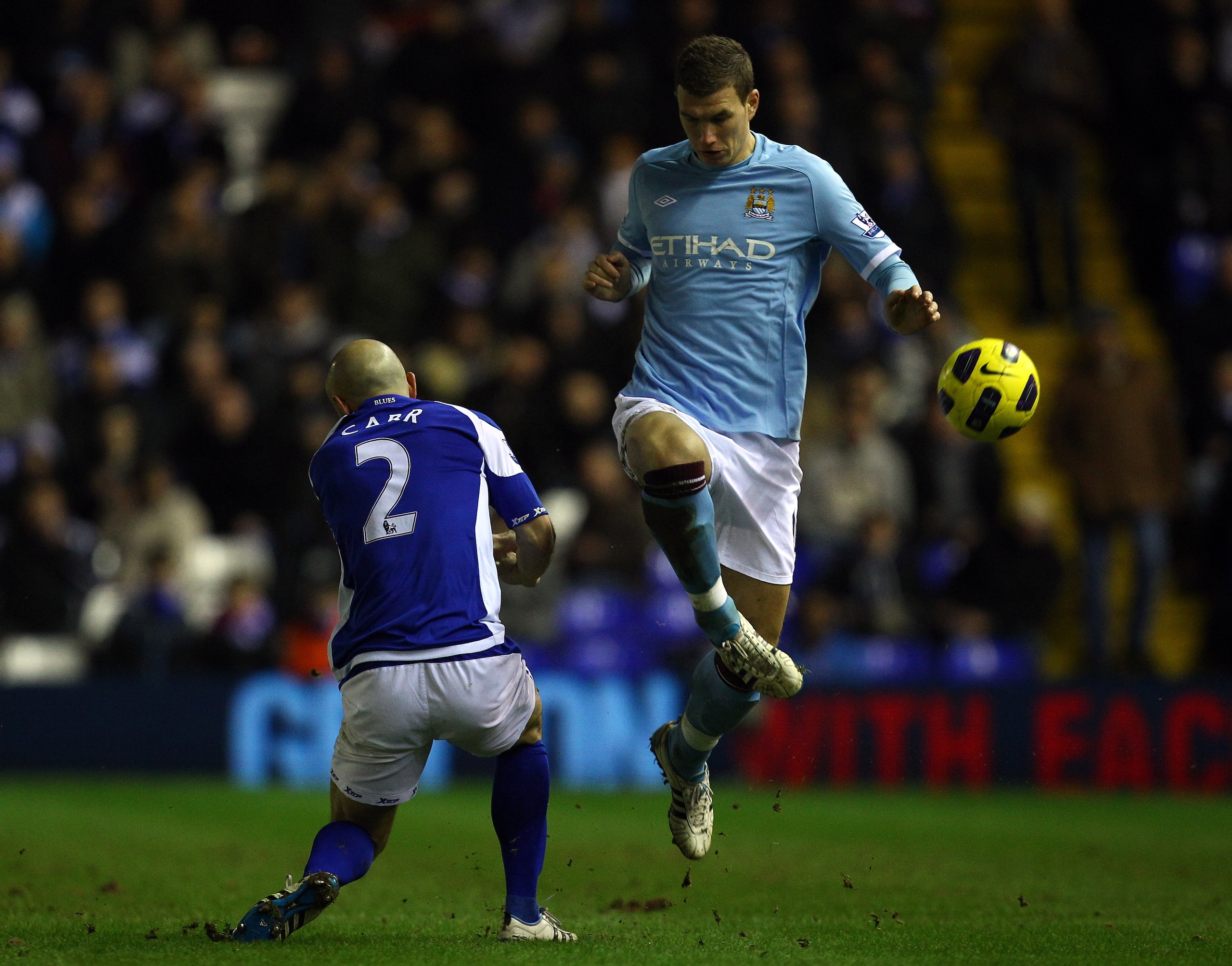 BIRMINGHAM, ENGLAND - FEBRUARY 02: Edin Dzeko of Manchester City goes past Stephen Carr of Birmingham during the Barclays premier league match between Birmingham City and Manchester City at St Andrews on February 2, 2011 in Birmingham, England. (Photo BIRMINGHAM, ENGLAND - FEBRUARY 02: Edin Dzeko of Manchester City goes past Stephen Carr of Birmingham during the Barclays premier league match between Birmingham City and Manchester City at St Andrews on February 2, 2011 in Birmingham, England. (Photo