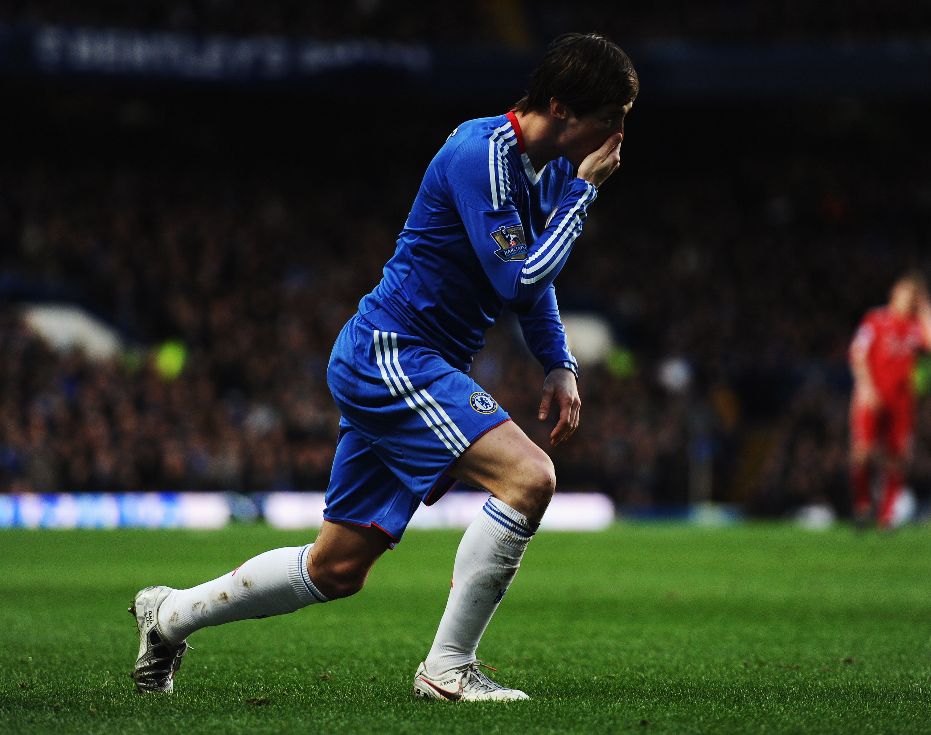LONDON, ENGLAND - FEBRUARY 06:  Fernando Torres of Chelsea holds his face after a challenge by Daniel Agger of Liverpool during the Barclays Premier League match between Chelsea and Liverpool at Stamford Bridge on February 6, 2011 in London, England.  (Ph