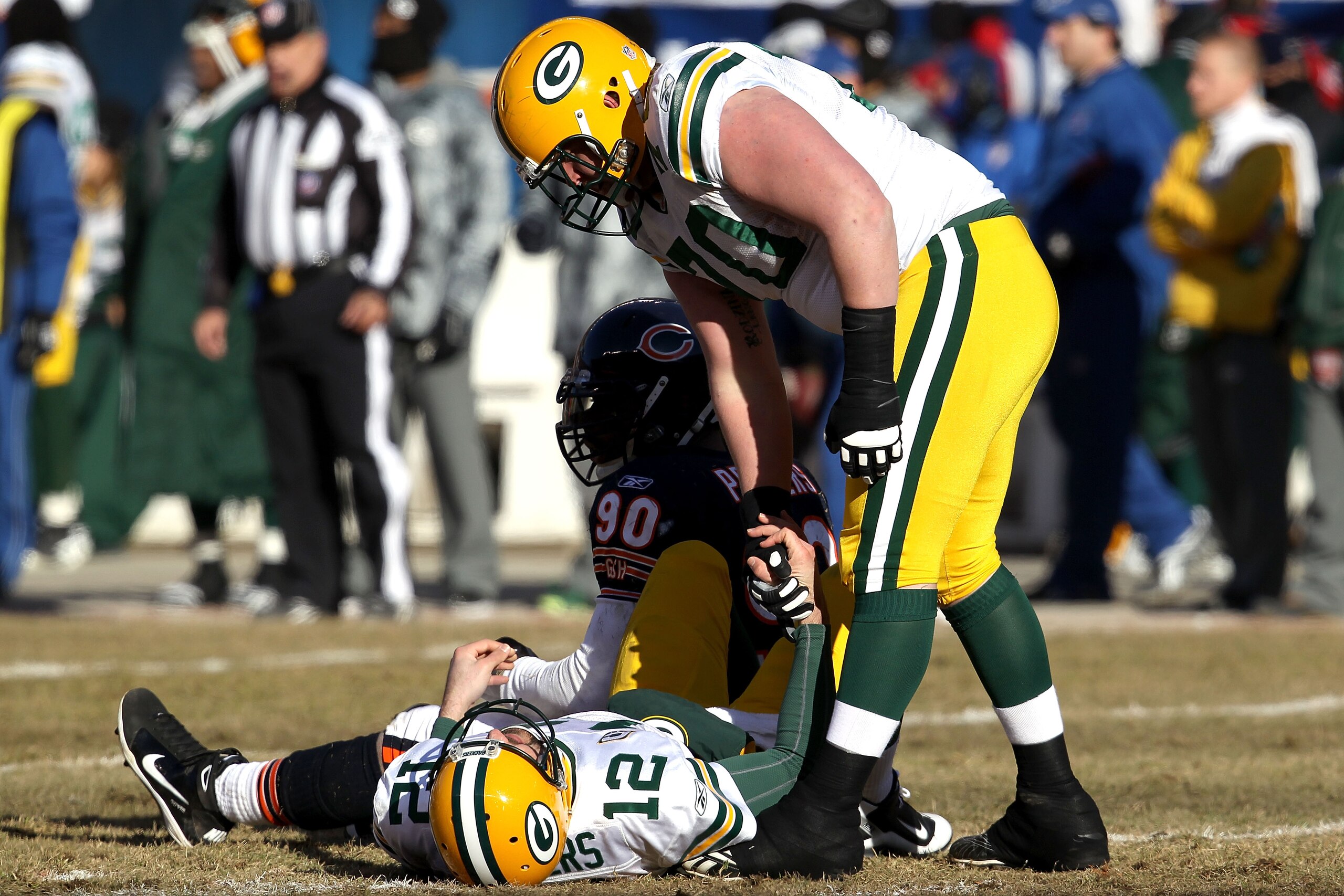 CHICAGO, IL - JANUARY 23: Quarterback Aaron Rodgers #12 of the Green Bay Packers lays on the turf after being knocked down by Julius Peppers #90 of the Chicago Bears in the first quarter in the NFC Championship Game at Soldier Field on January 23, 2011 i CHICAGO, IL - JANUARY 23: Quarterback Aaron Rodgers #12 of the Green Bay Packers lays on the turf after being knocked down by Julius Peppers #90 of the Chicago Bears in the first quarter in the NFC Championship Game at Soldier Field on January 23, 2011 i