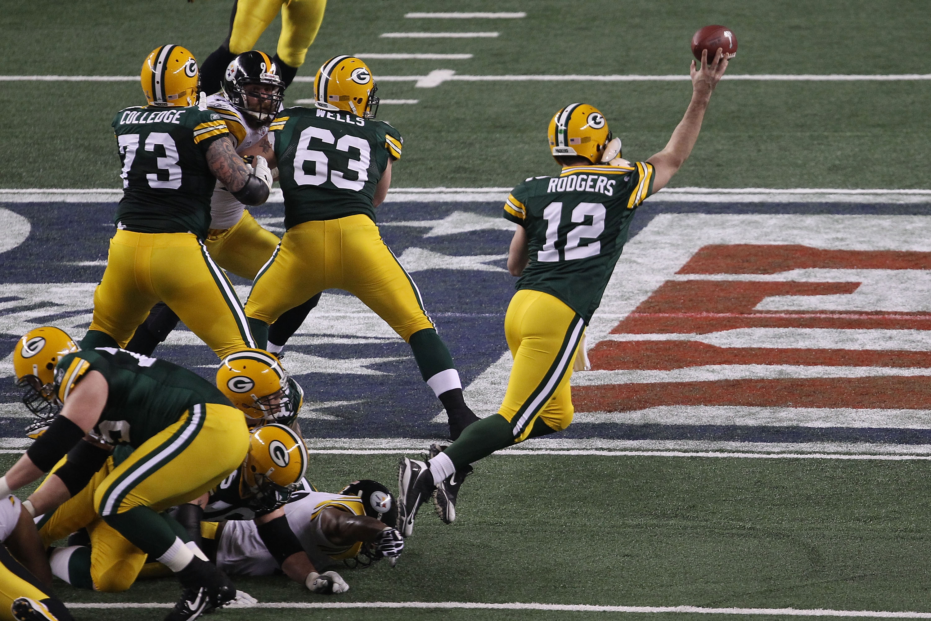 ARLINGTON, TX - FEBRUARY 06:  Aaron Rodgers #12 of the Green Bay Packers throws a pass against the Pittsburgh Steelers during Super Bowl XLV at Cowboys Stadium on February 6, 2011 in Arlington, Texas.  (Photo by Jonathan Daniel/Getty Images)