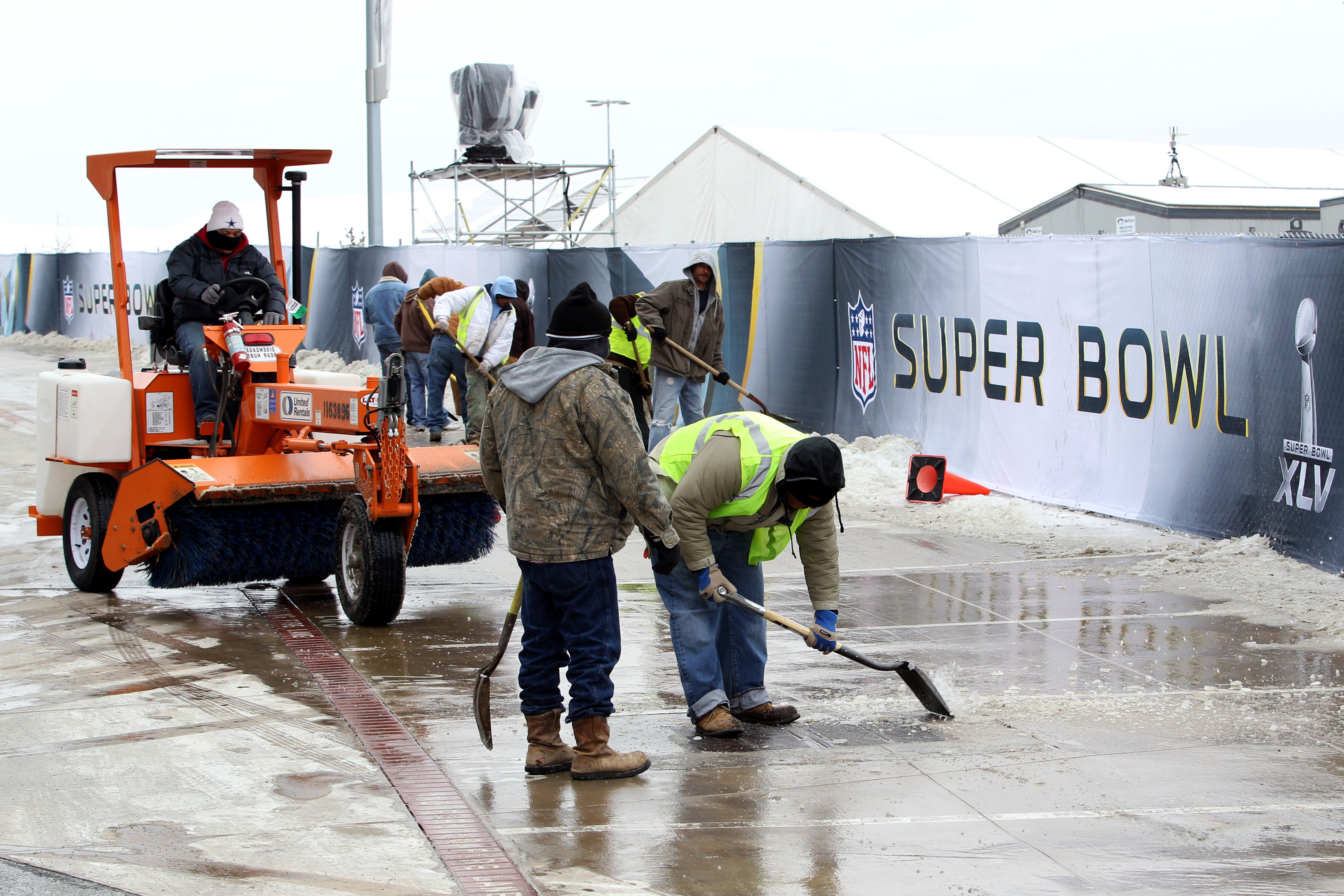 ARLINGTON, TX - FEBRUARY 03:  Workers use shovels and machinery to clear ice and snow on February 3, 2011 outside of Cowboy Stadium in Arlington, Texas. Cowboys Stadium will host Super Bowl XLV on February 6, 2011 between the Pittsburgh Steelers and the G