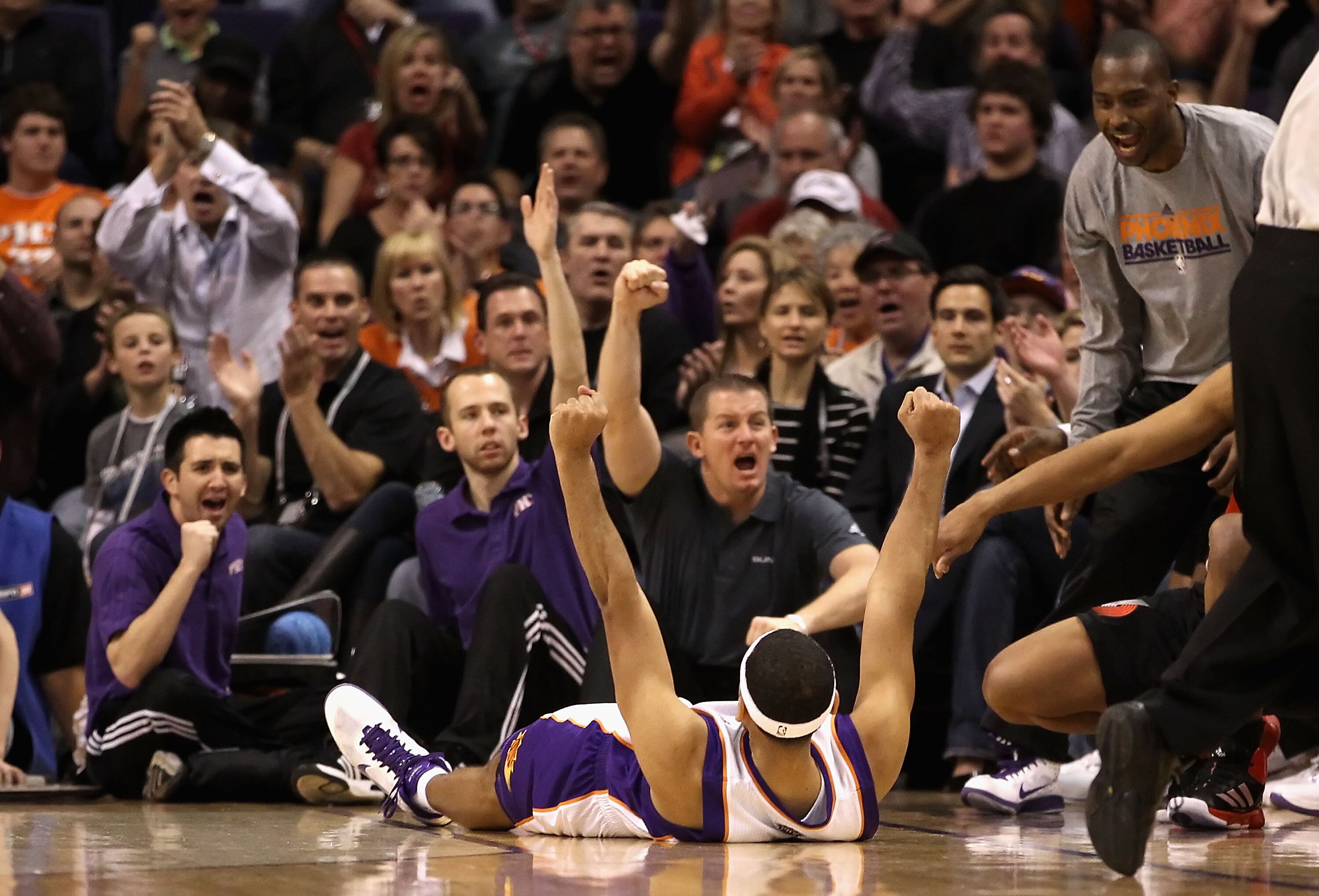 PHOENIX, AZ - JANUARY 14:  Jared Dudley #3 of the Phoenix Suns celebrates from the floor after hitting a three point shot against the Portland Trail Blazers during the NBA game at US Airways Center on January 14, 2011 in Phoenix, Arizona.  NOTE TO USER: U