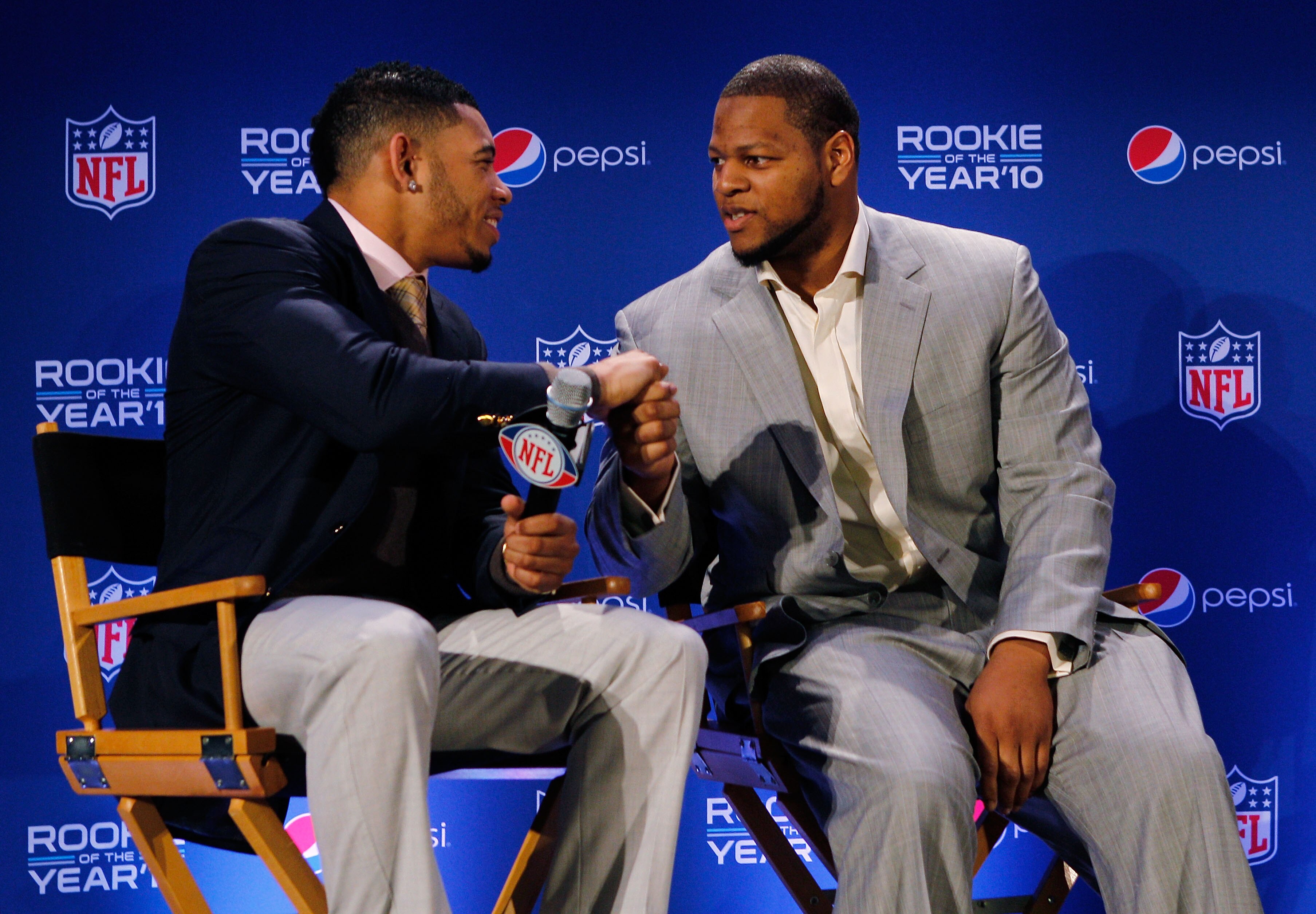 DALLAS, TX - FEBRUARY 03:  Ndamukong Suh (R) #90 of the Detroit Lions shakes hands with Joe Haden #23 of the Cleveland Browns during a press conference where Suh accepted Pepsi's 2010 NFL Rookie of the Year Award at the Super Bowl XLV media center on Febr