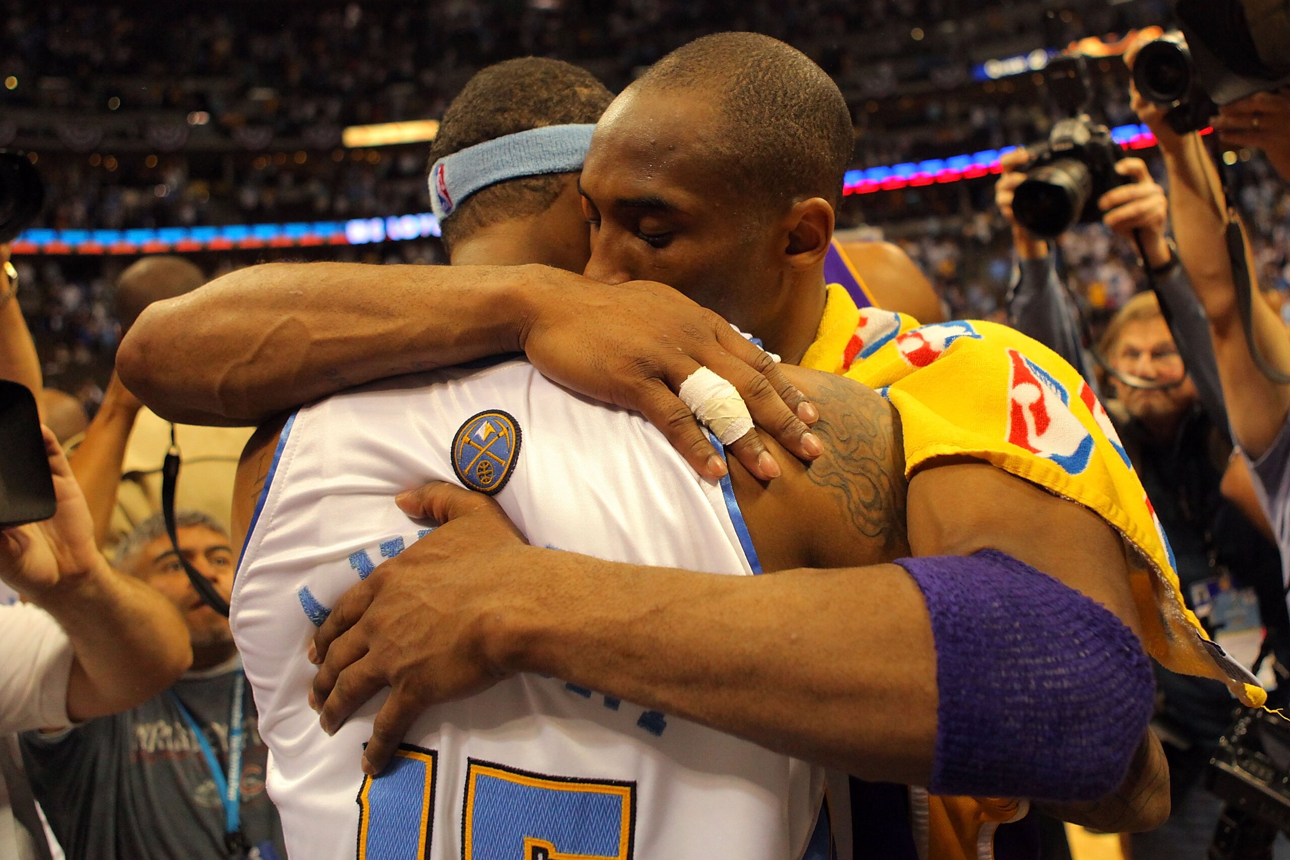 DENVER - MAY 29:  Kobe Bryant #24 of the Los Angeles Lakers hugs Carmelo Anthony #15 of the Denver Nuggets after the Lakers defeated the Nuggets 119-92 in Game Six of the Western Conference Finals during the 2009 NBA Playoffs at Pepsi Center on May 29, 20