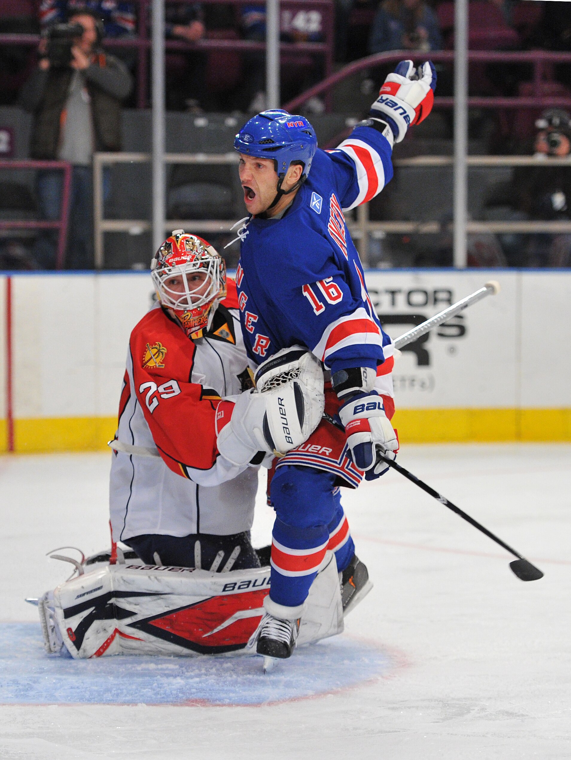 NEW YORK, NY - JANUARY 25: Sean Avery #16 of the New York Rangers collides with Tomas Vokoun #29 of the Florida Panthers during the second period at Madison Square Garden on January 25, 2011 in New York City. (Photo by Christopher Pasatieri/Getty Images)
