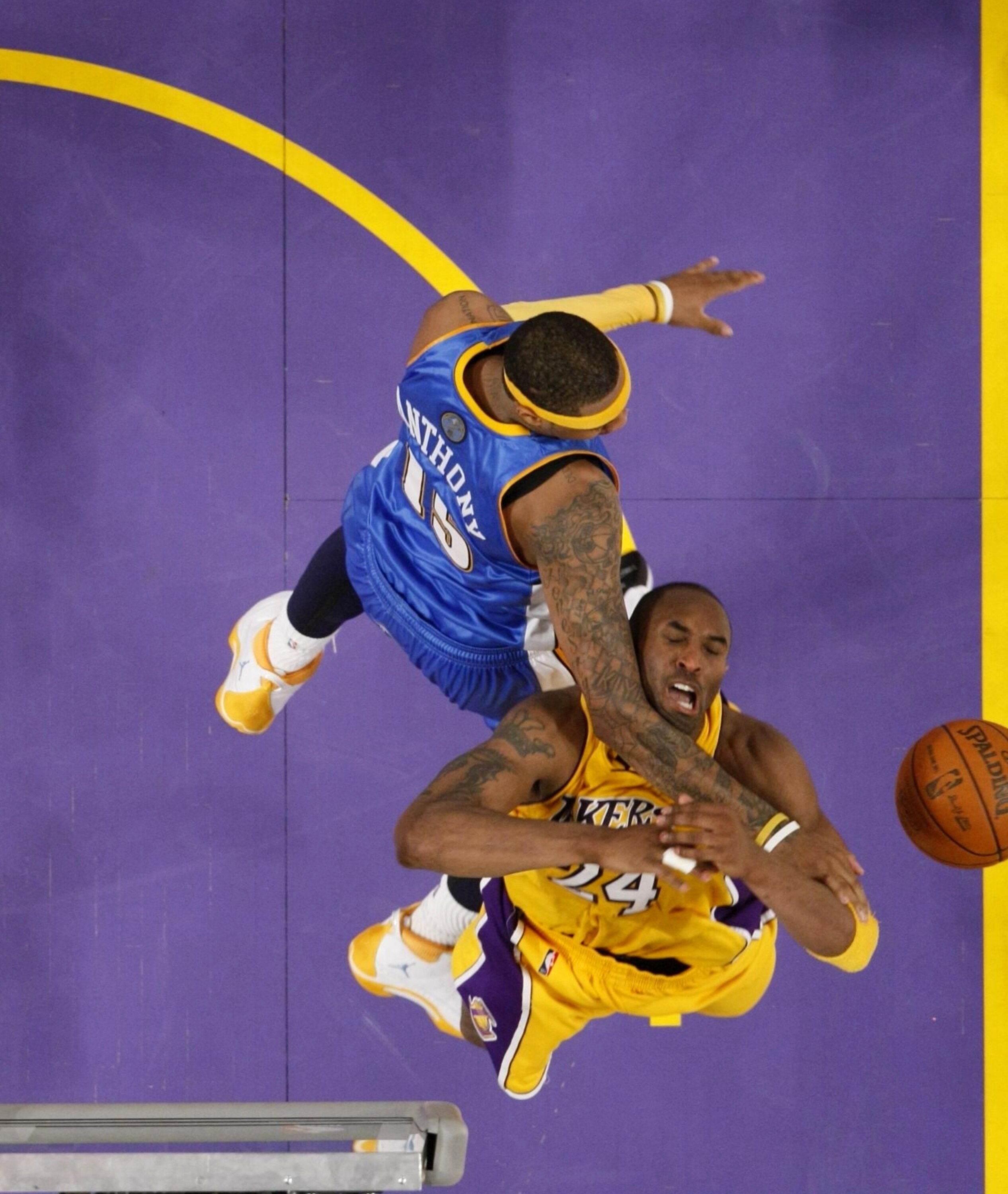 LOS ANGELES, CA - MAY 27:  Kobe Bryant #24 of the Los Angeles Lakers is fouled on the way to the basket by Carmelo Anthony #15 of the Denver Nuggets in Game Five of the Western Conference Finals during the 2009 NBA Playoffs at Staples Center on May 27, 20