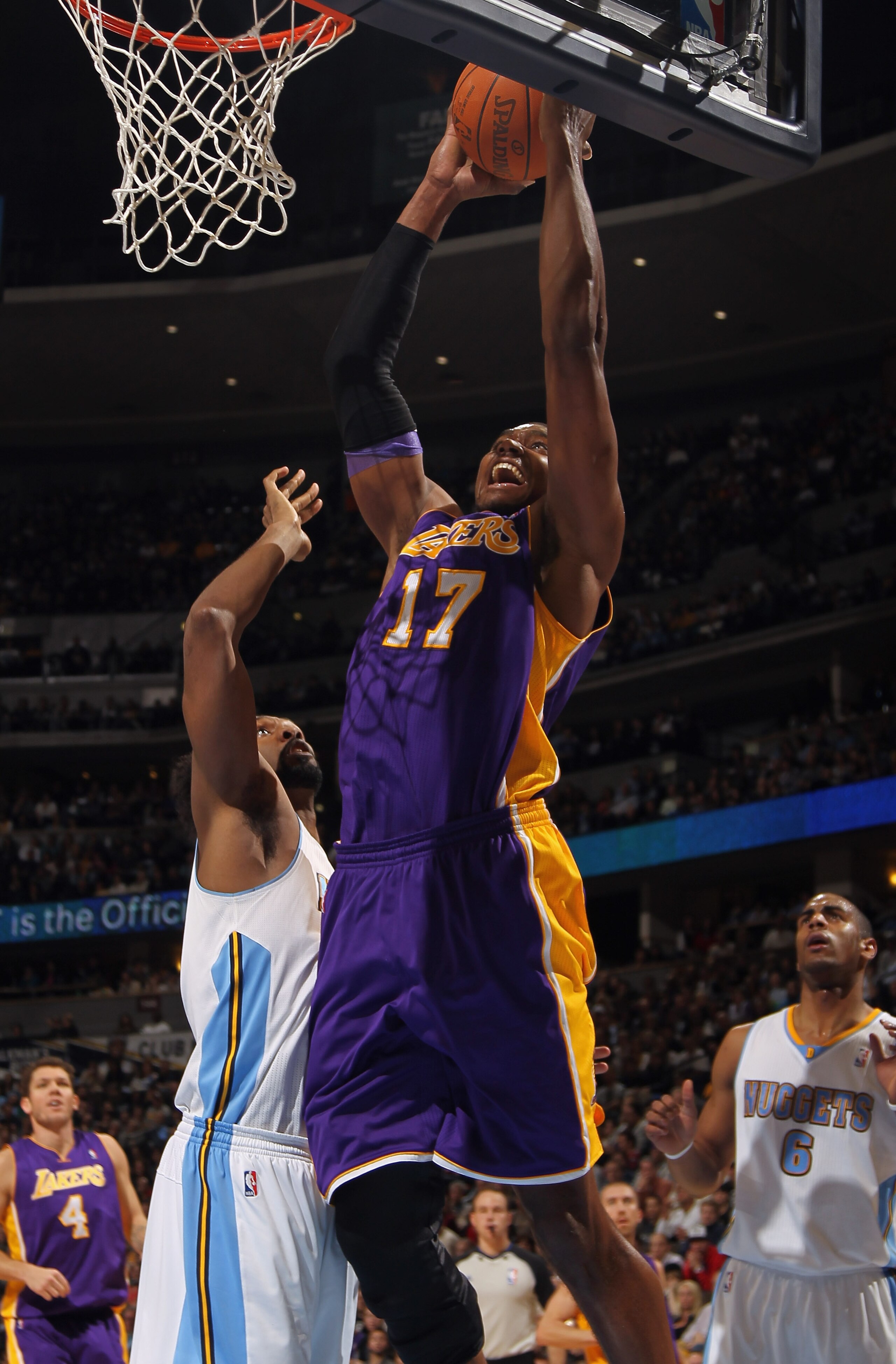 DENVER, CO - JANUARY 21: Andrew Bynum #17 of the Los Angeles Lakers takes a shot against Nene #31 of the Denver Nuggets at the Pepsi Center on January 21, 2011 in Denver, Colorado. NOTE TO USER: User expressly acknowledges and agrees that, by downloading DENVER, CO - JANUARY 21: Andrew Bynum #17 of the Los Angeles Lakers takes a shot against Nene #31 of the Denver Nuggets at the Pepsi Center on January 21, 2011 in Denver, Colorado. NOTE TO USER: User expressly acknowledges and agrees that, by downloading