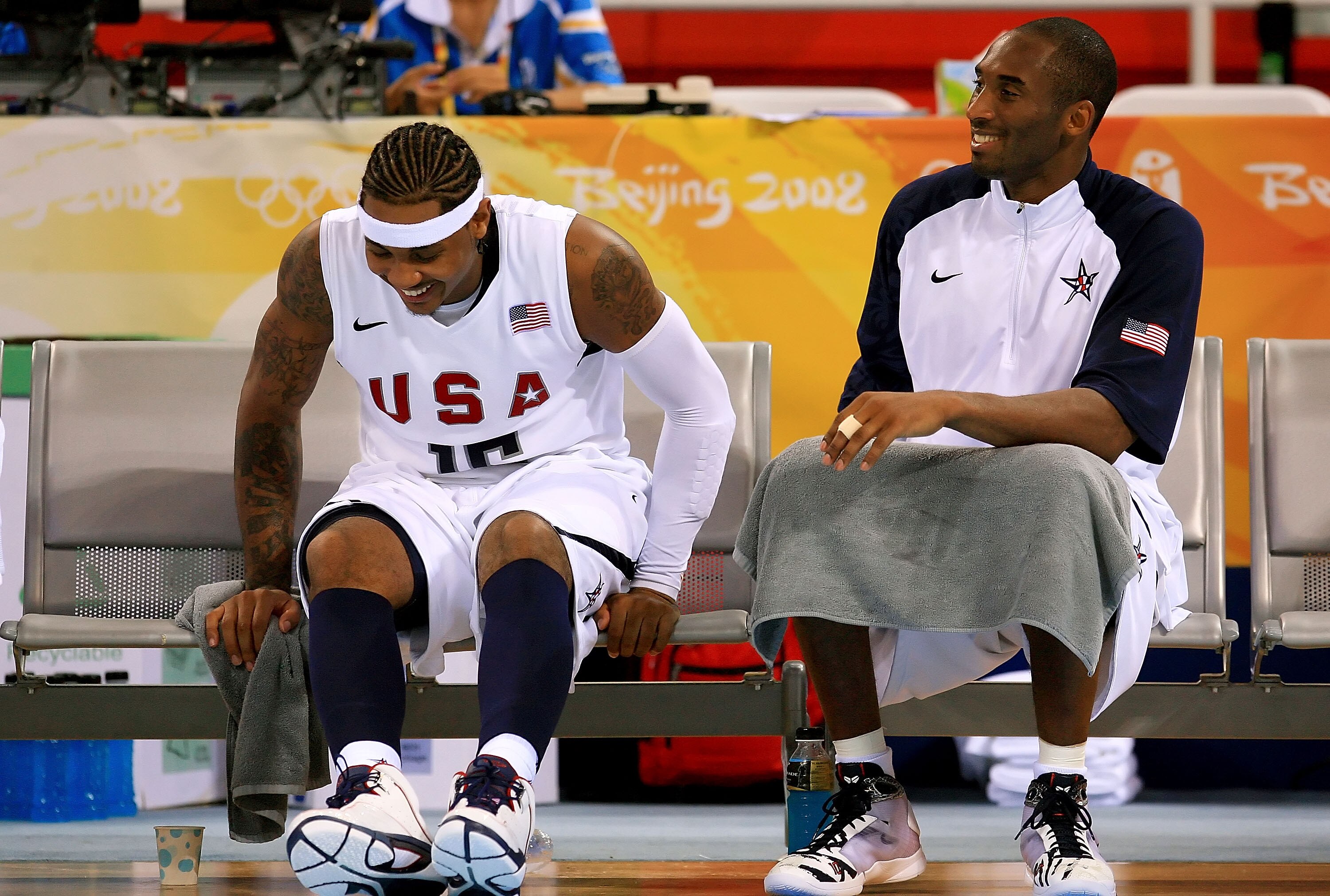BEIJING - AUGUST 18:  Carmelo Anthony #15 and Kobe Bryant #10 of the United States share a laugh on the bench during the men?s basketball preliminaries against Germany at the Wukesong Indoor Stadium on Day 10 of the Beijing 2008 Olympic Games on August 18