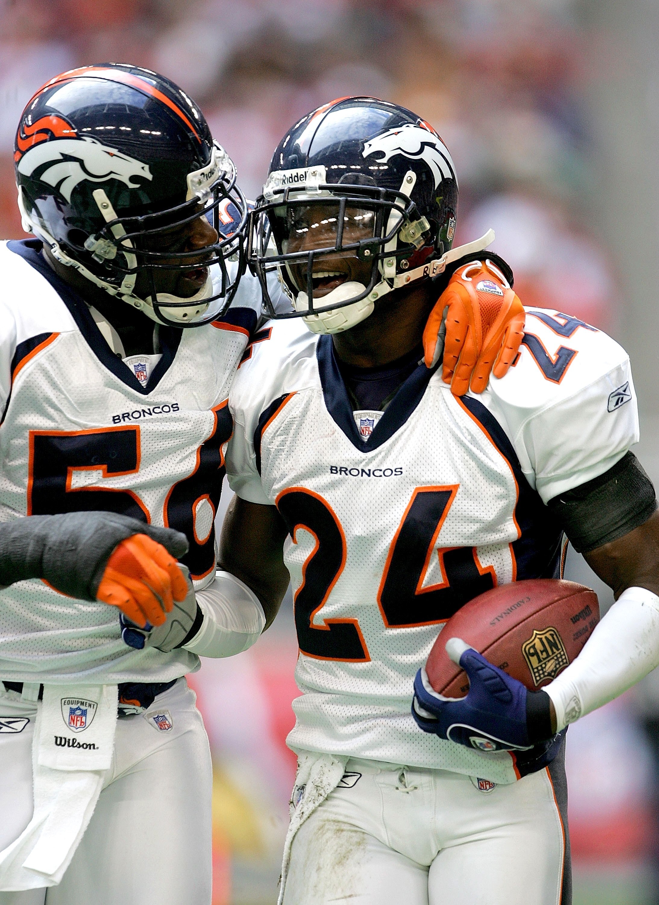 GLENDALE, AZ - DECEMBER 17: Cornerback Champ Bailey #24 and linebacker Al Wilson #56 of the Denver Broncos celebrate after Bailey's first quarter pass interception against the Arizona Cardinals on December 17, 2006 at University of Phoenix Stadium in Glen