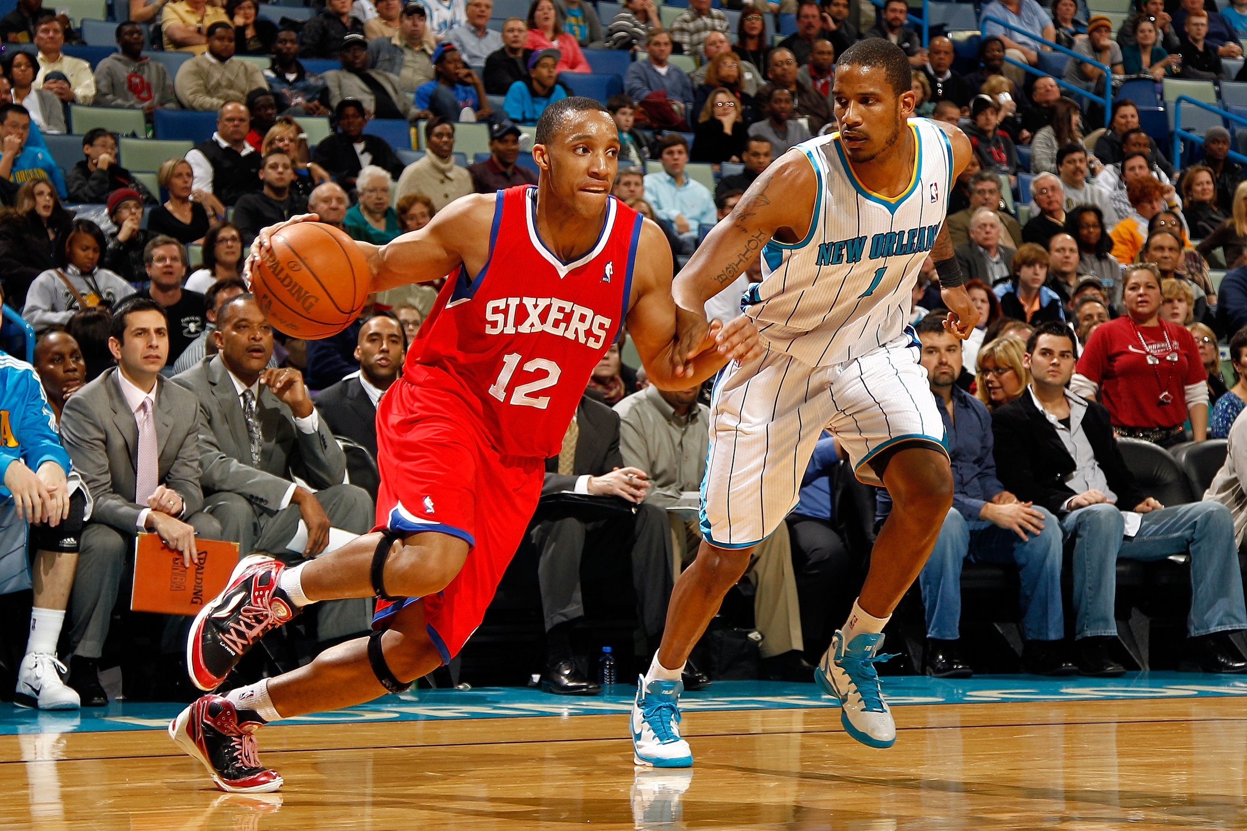 NEW ORLEANS, LA - JANUARY 03: Evan Turner #12 of the Philadelphia 76ers drives on Trevor Ariza #1 of the New Orleans Hornets in the second half at New Orleans Arena on January 3, 2011 in New Orleans, Louisiana. NOTE TO USER: User expressly acknowledges a NEW ORLEANS, LA - JANUARY 03: Evan Turner #12 of the Philadelphia 76ers drives on Trevor Ariza #1 of the New Orleans Hornets in the second half at New Orleans Arena on January 3, 2011 in New Orleans, Louisiana. NOTE TO USER: User expressly acknowledges a