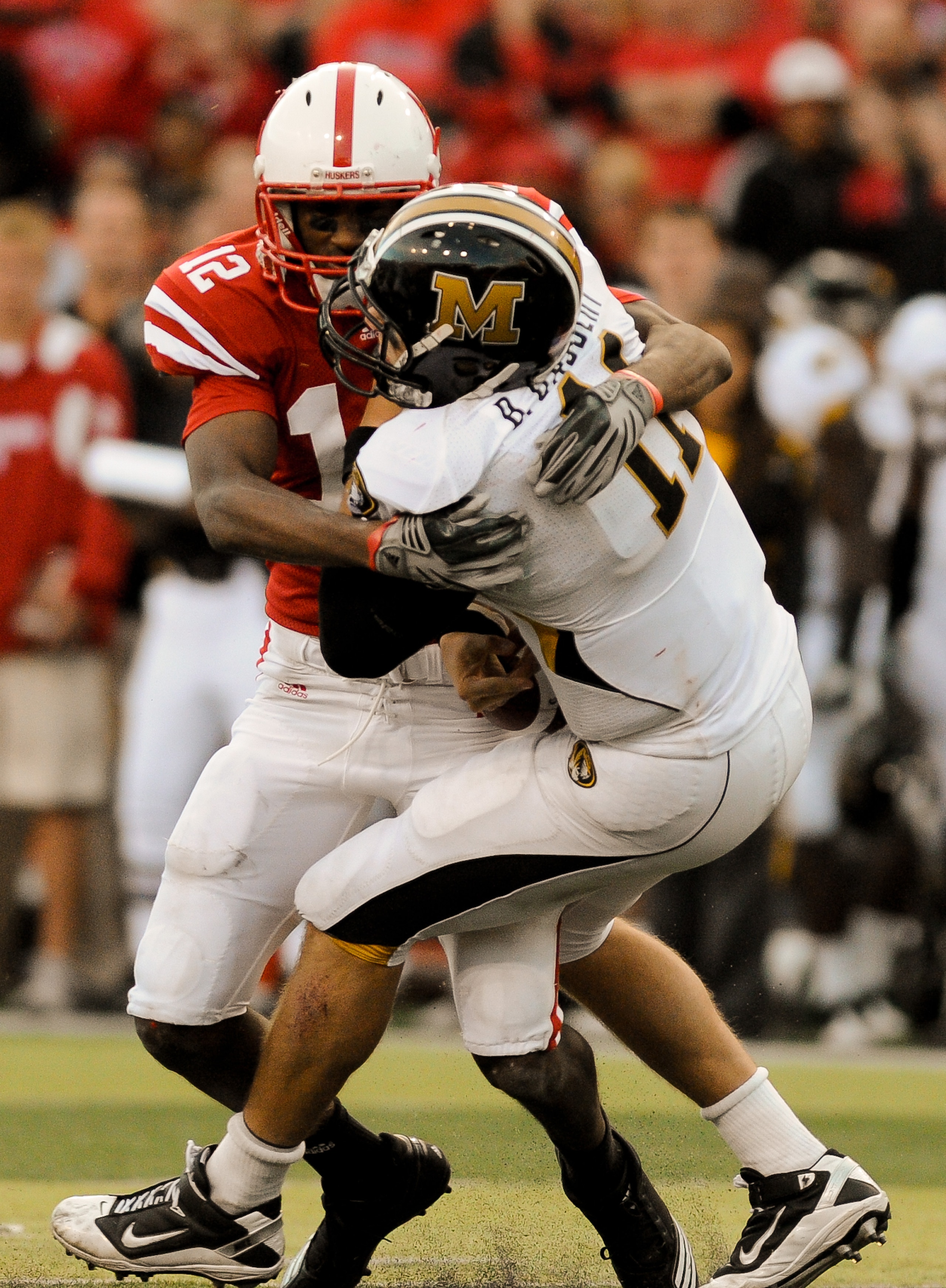 LINCOLN, NE - OCTOBER 30: Safety Courtney Osborne #12 of the Nebraska Cornhuskers hits  quarterback Blaine Gabbert #11 of the Missouri Tigers during second half action of their game at Memorial Stadium on October 30, 2010 in Lincoln, Nebraska. Nebraska De