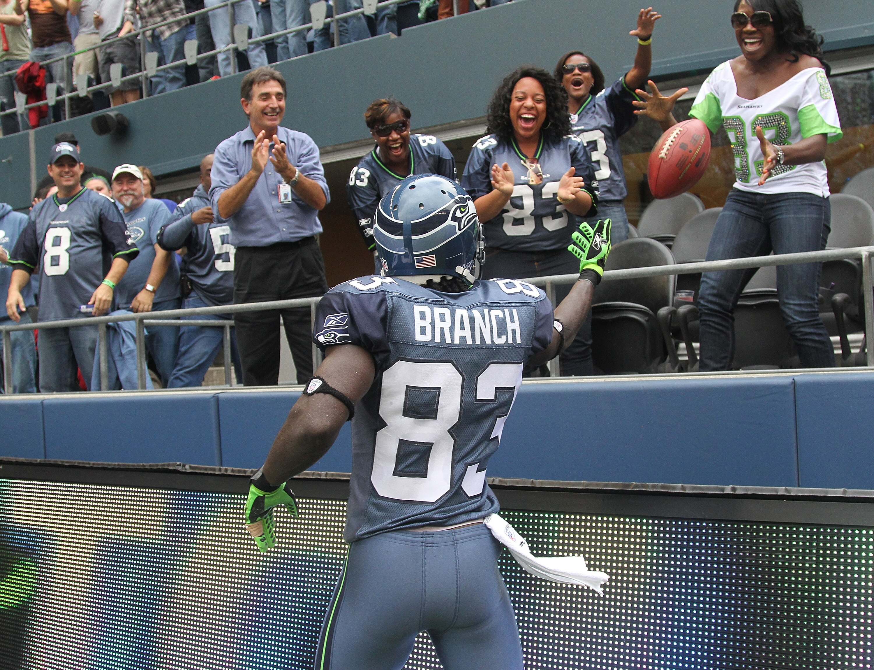 SEATTLE - SEPTEMBER 26:  Wide receiver Deion Branch #83 of the Seattle Seahawks tosses the ball to fans after scoring a touchdown against the San Diego Chargers at Qwest Field on September 26, 2010 in Seattle, Washington. The Seahawks defeated the Charger